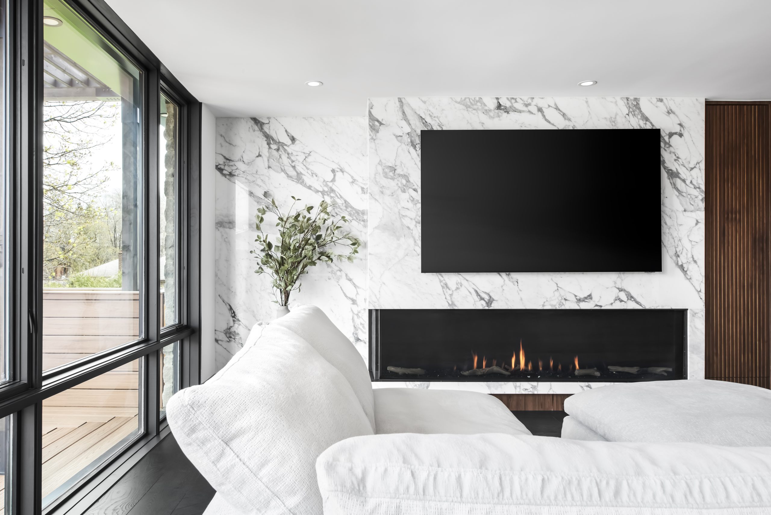 Modern fireplace wall facing a garden terrace