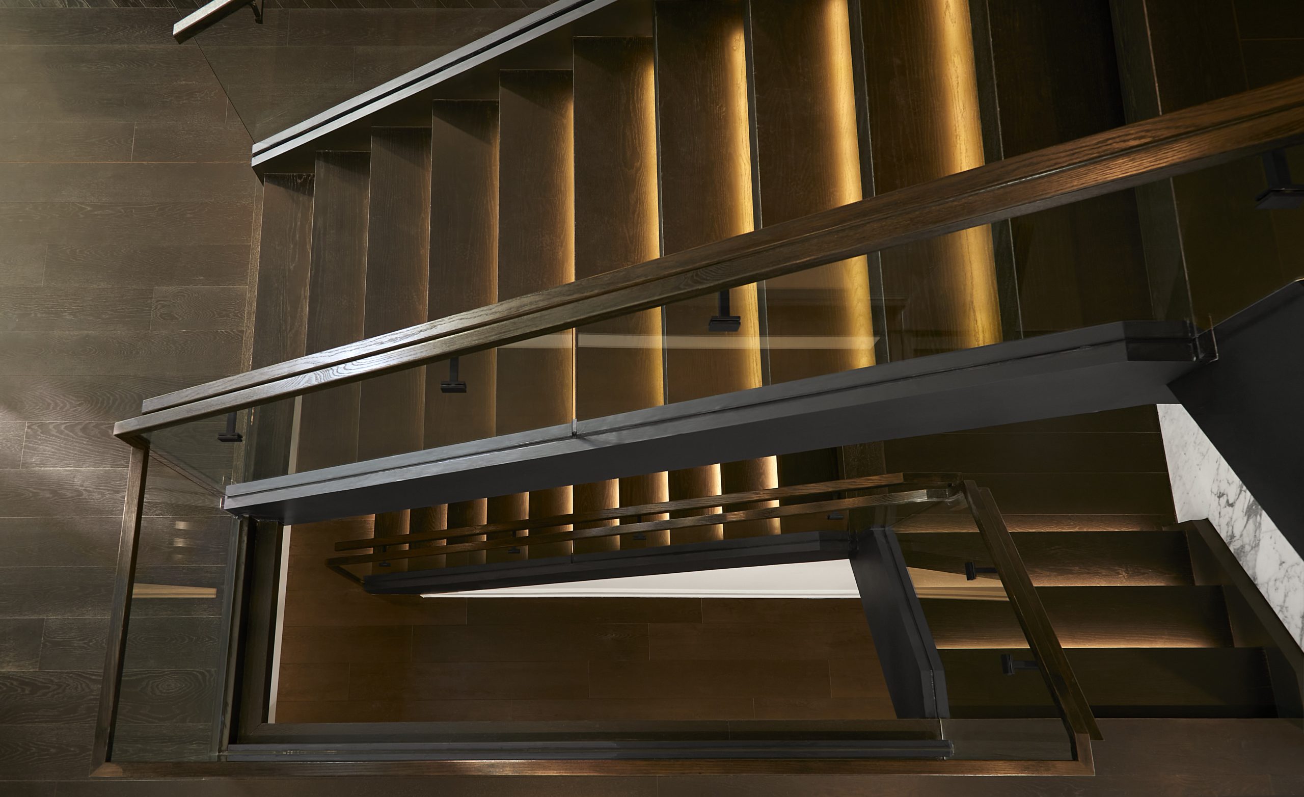 Illuminated floating staircase inside Modern Astoria