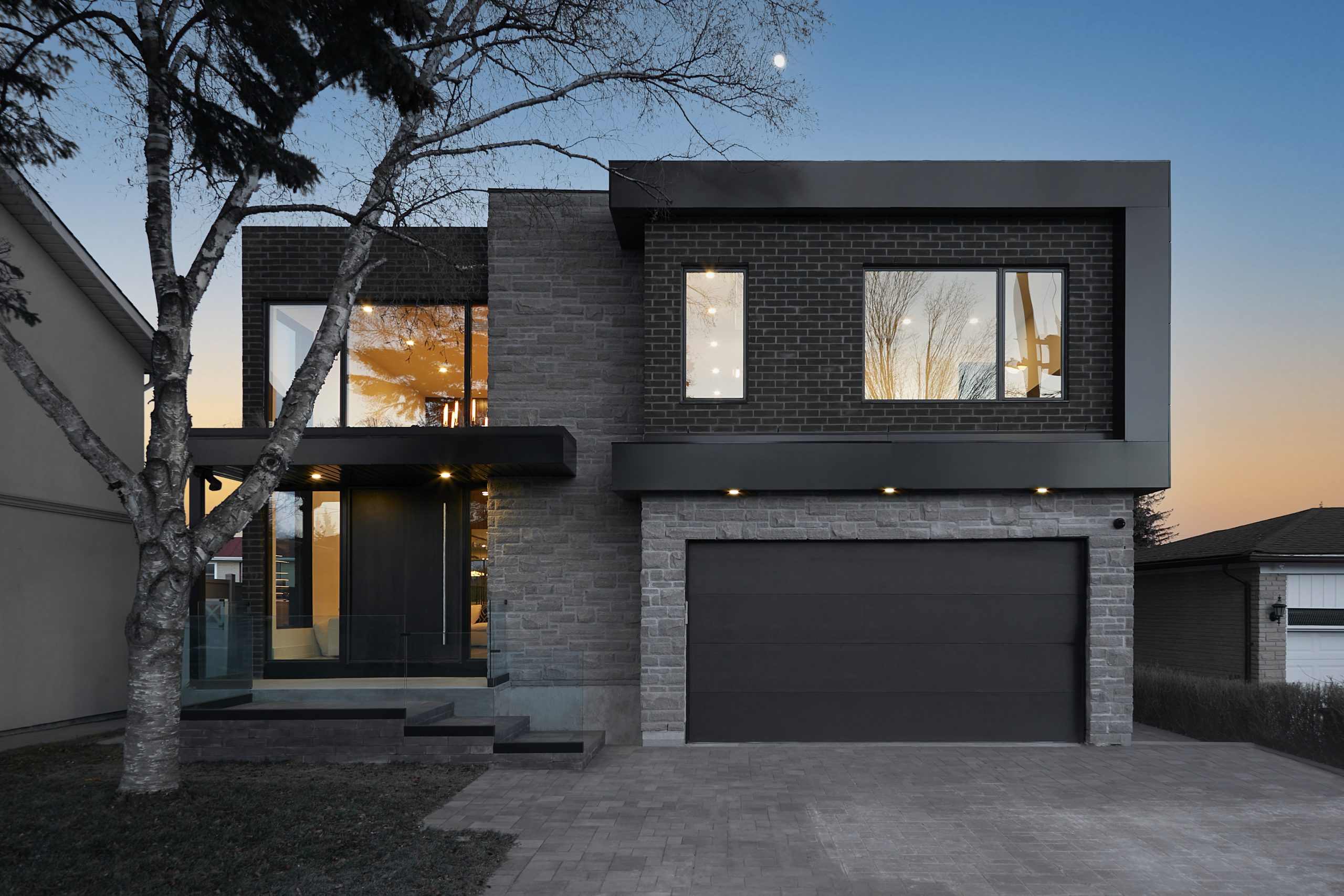 Modern Astoria residence with layered stone, brick and glass volumes