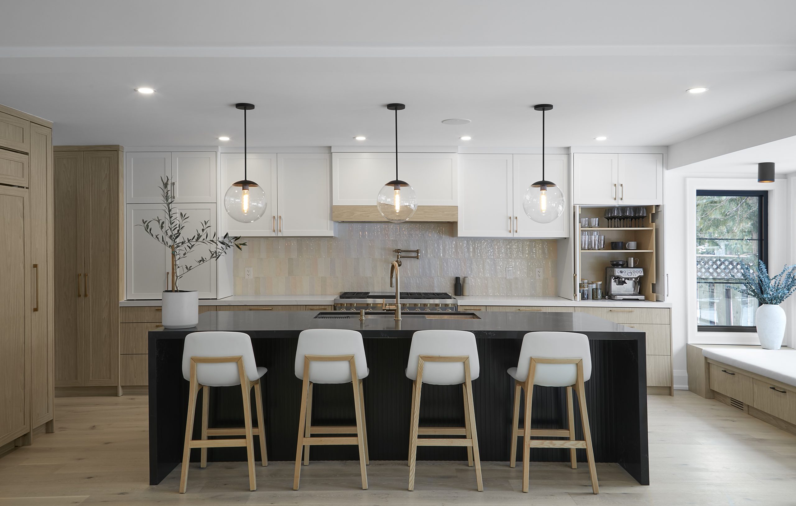 Neutral kitchen with a dark island and garden doors