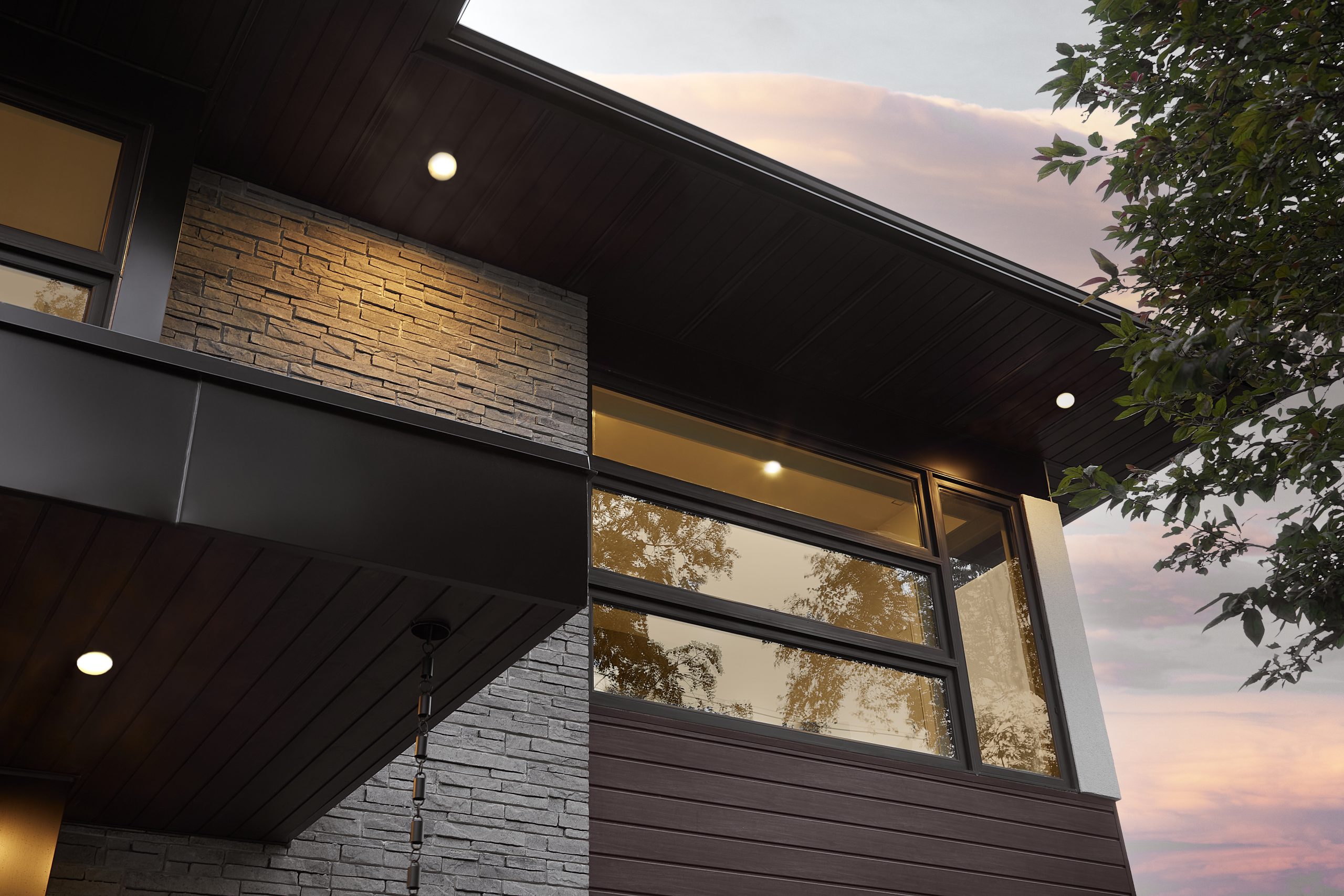 Close view of the deep roof overhang and upper windows