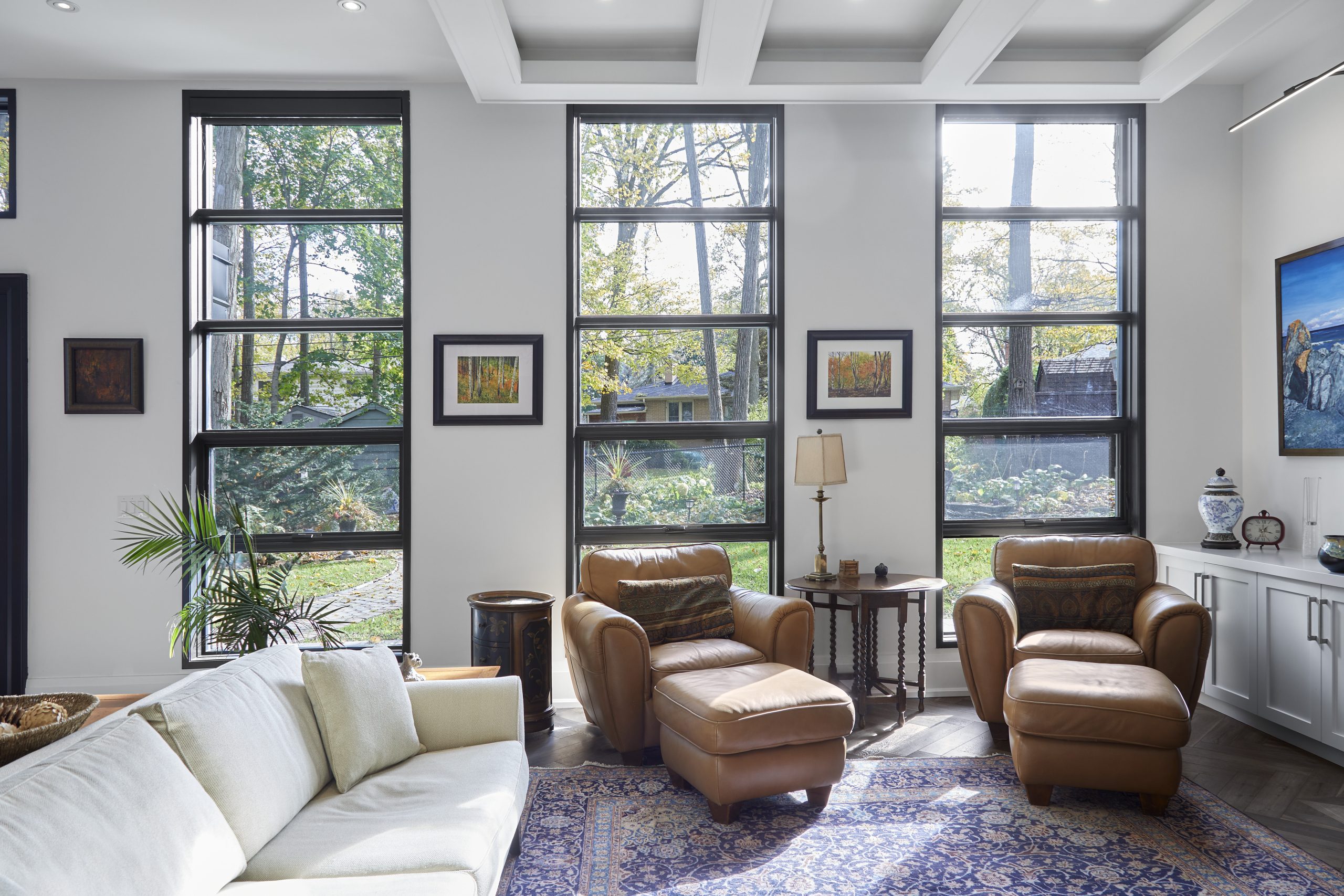 Warm foyer with paneled walls and dark herringbone floors