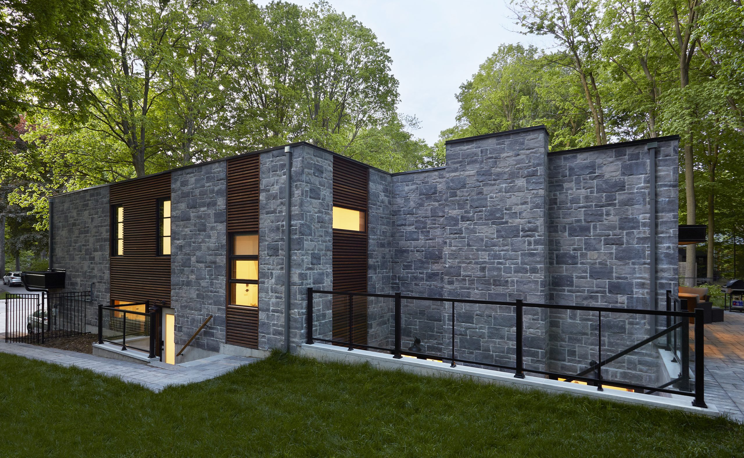Long low bungalow proportions framed by mature trees