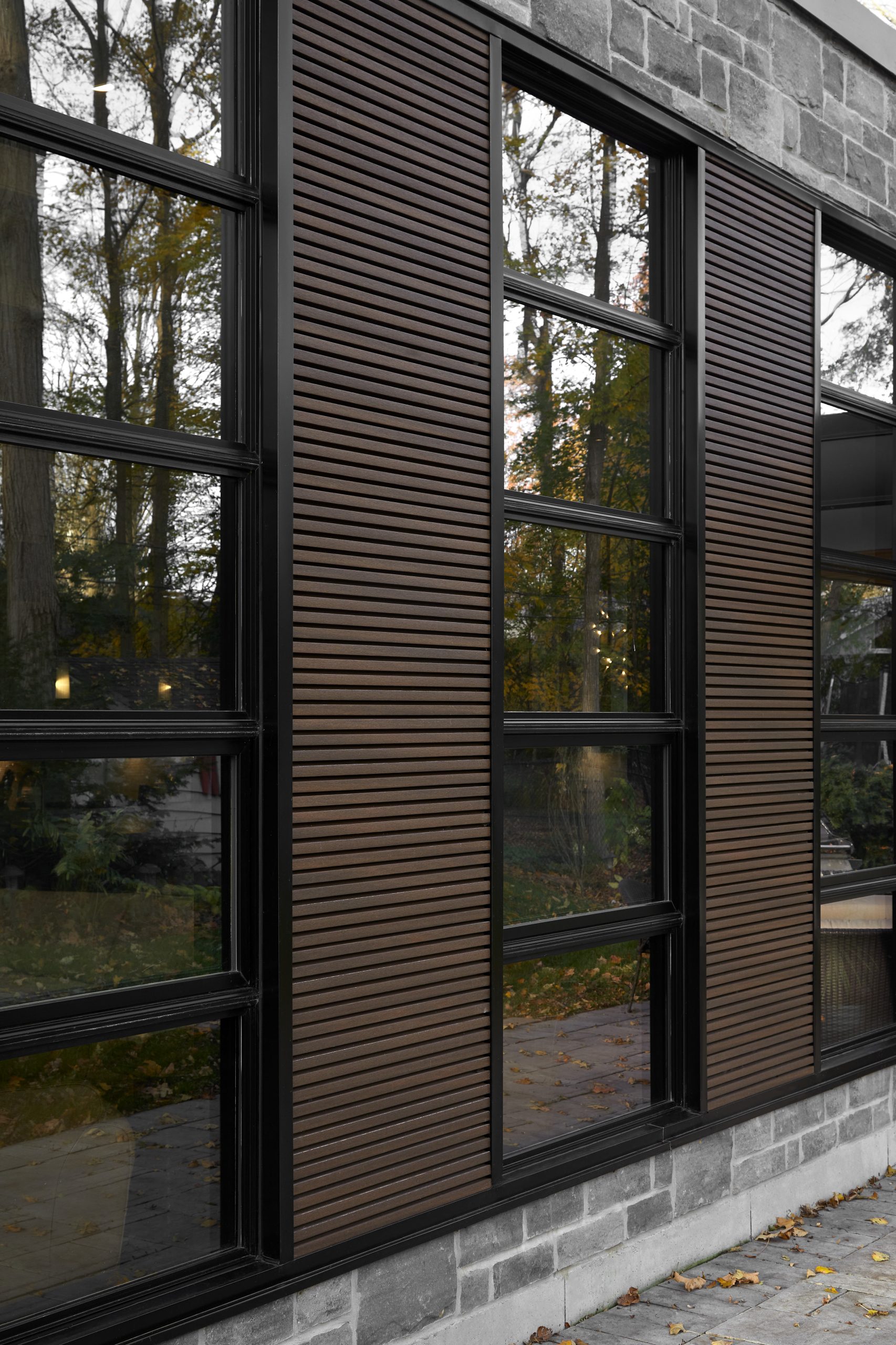 Floor-to-ceiling glazing and stone wall at Forestview Bungalow