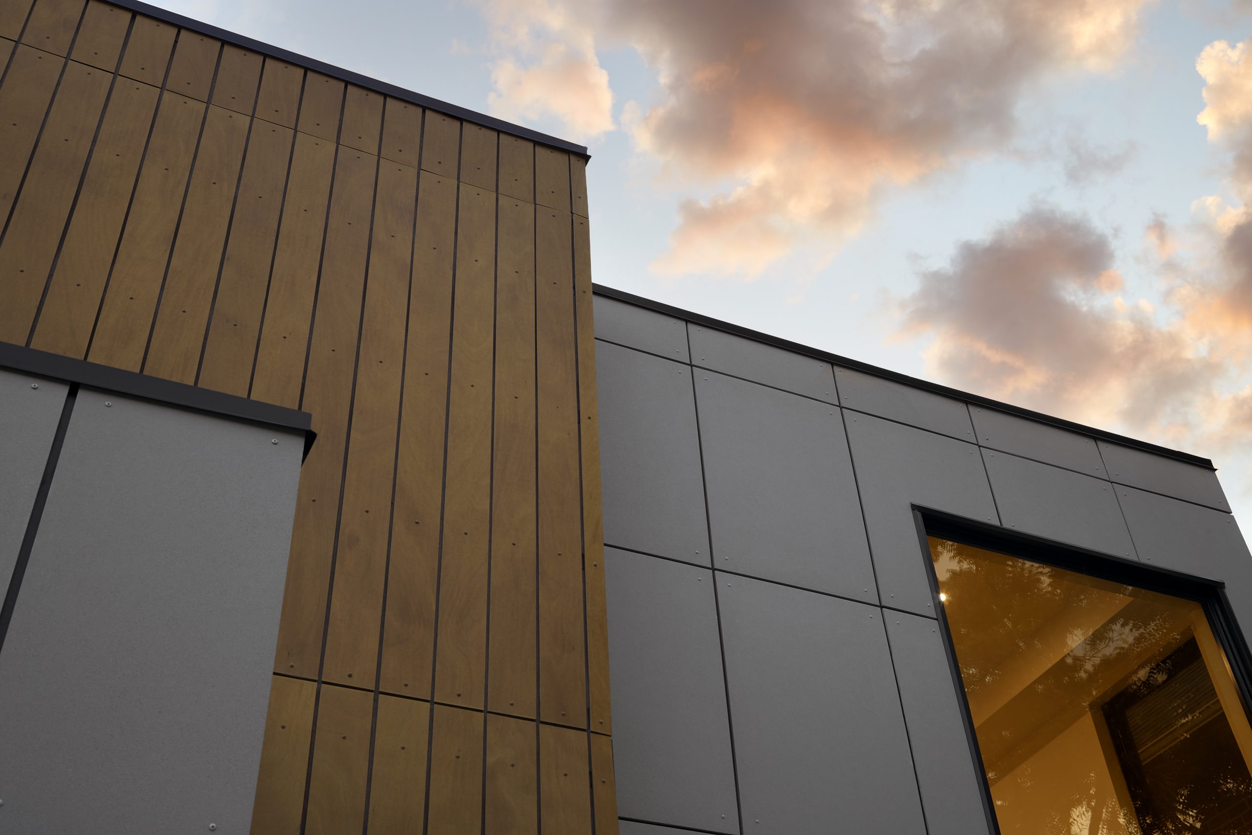 Upper facade detail beneath a softly lit evening sky