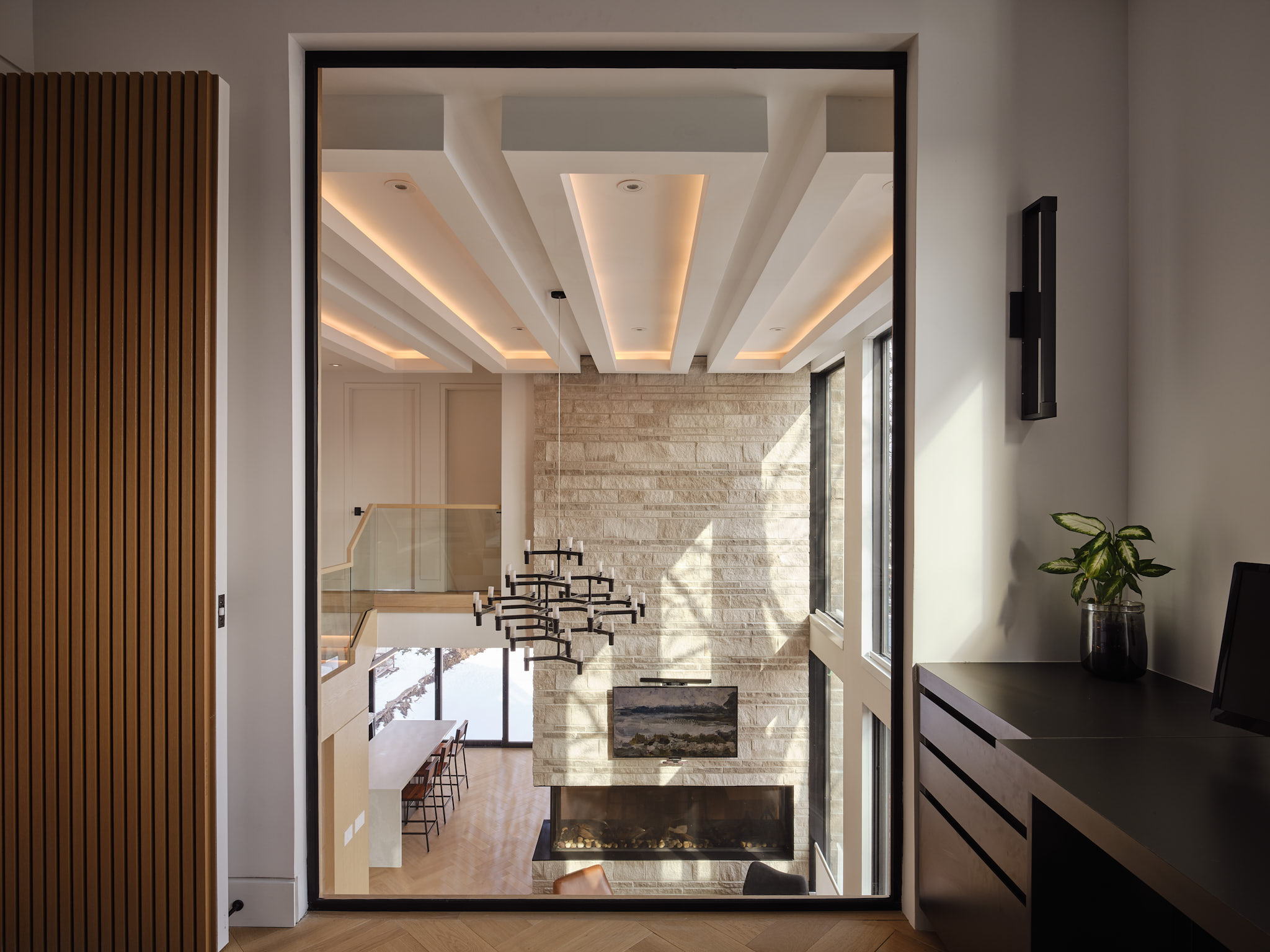 View through a dark framed opening to the living room