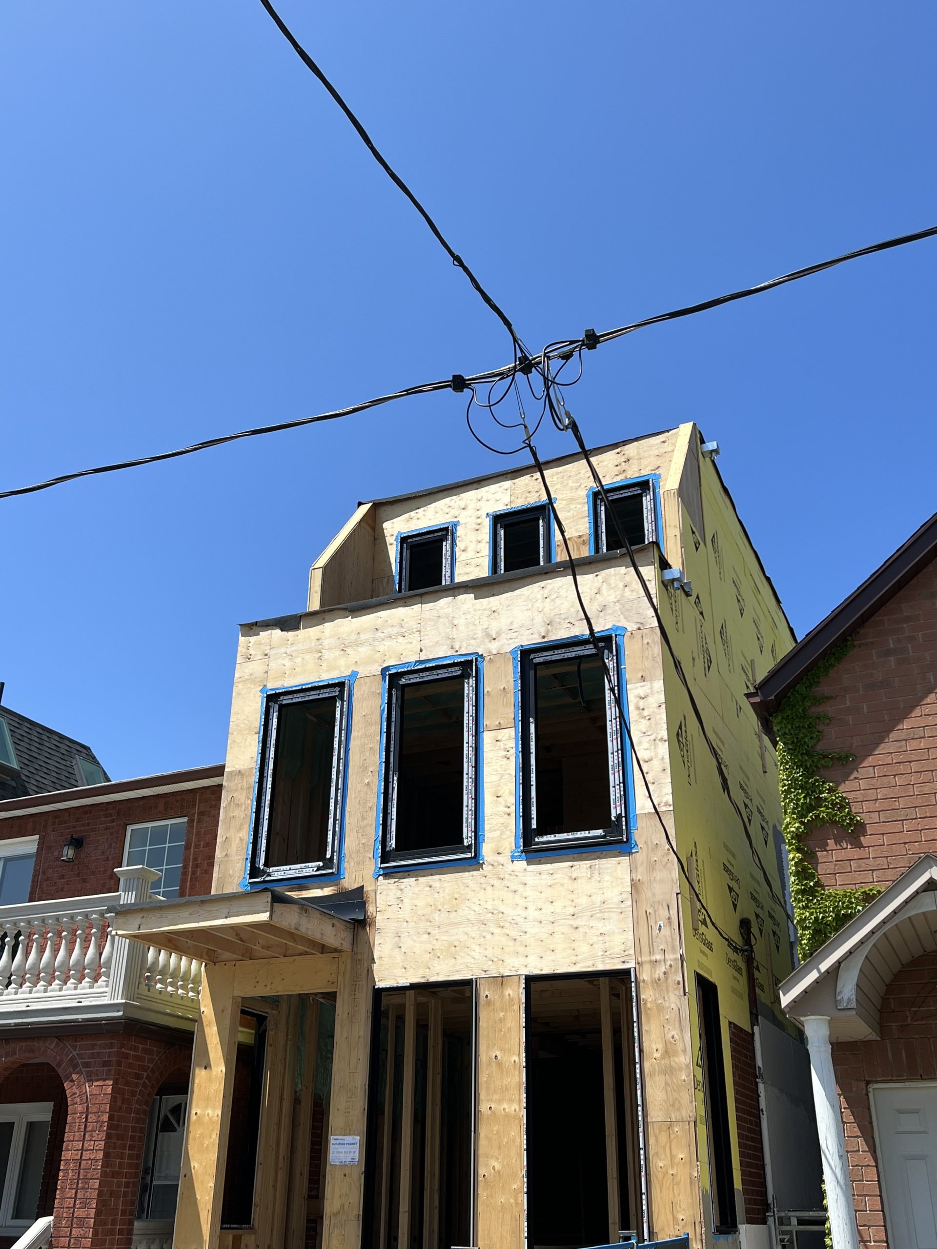 Angled view of the brownstone framing and window installation