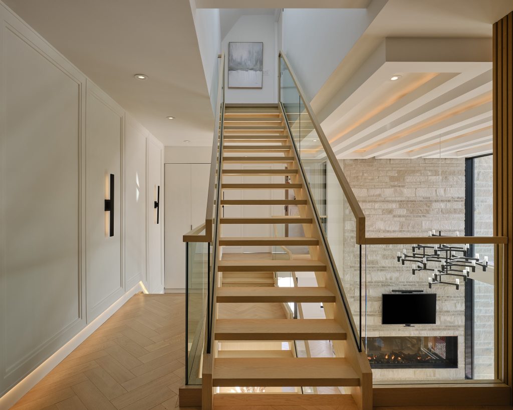 Open timber staircase with lighting along the wall and ceiling