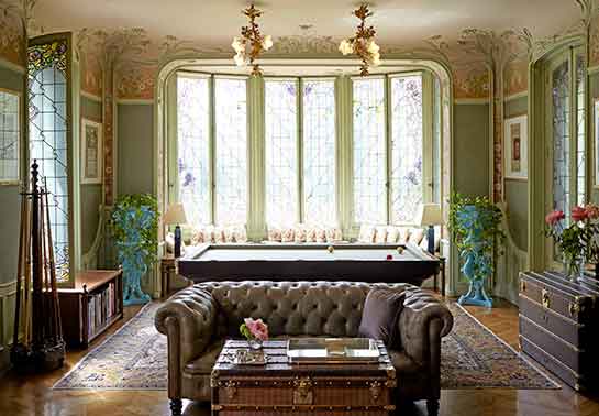 Leather sofa and Louis Vuitton trunk in a richly decorated sitting room
