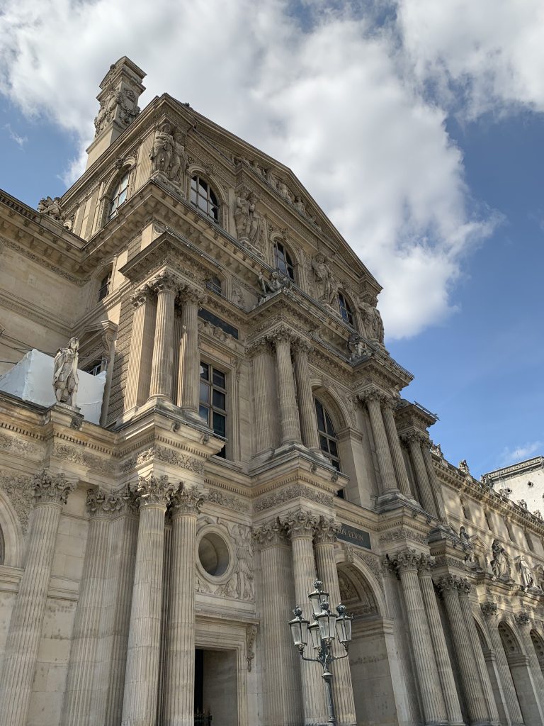 Carved stone facade and roof pavilion of the Louvre