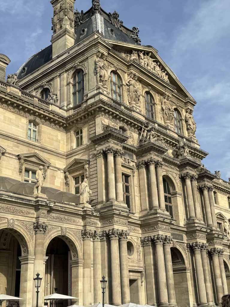 Tall Louvre pavilion with a steep roof and ornate stonework