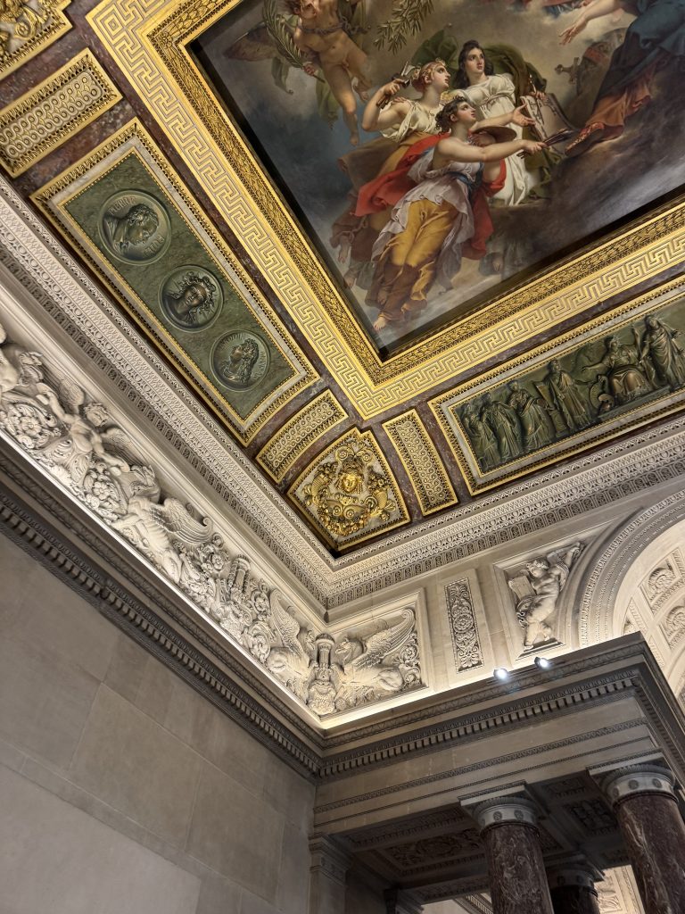 Painted ceiling panel surrounded by carved and gilded mouldings