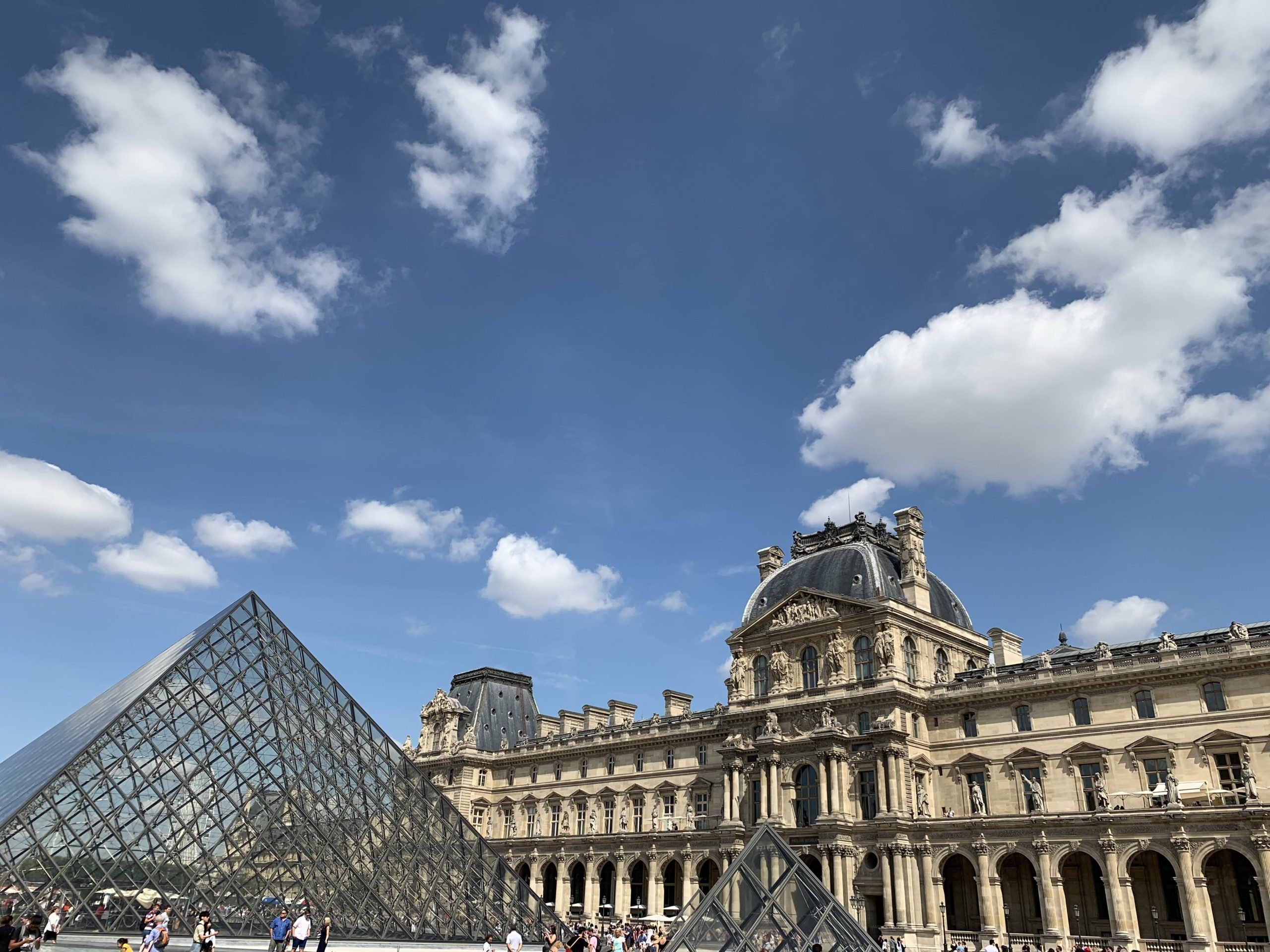 Louvre glass pyramid beside the historic palace facade