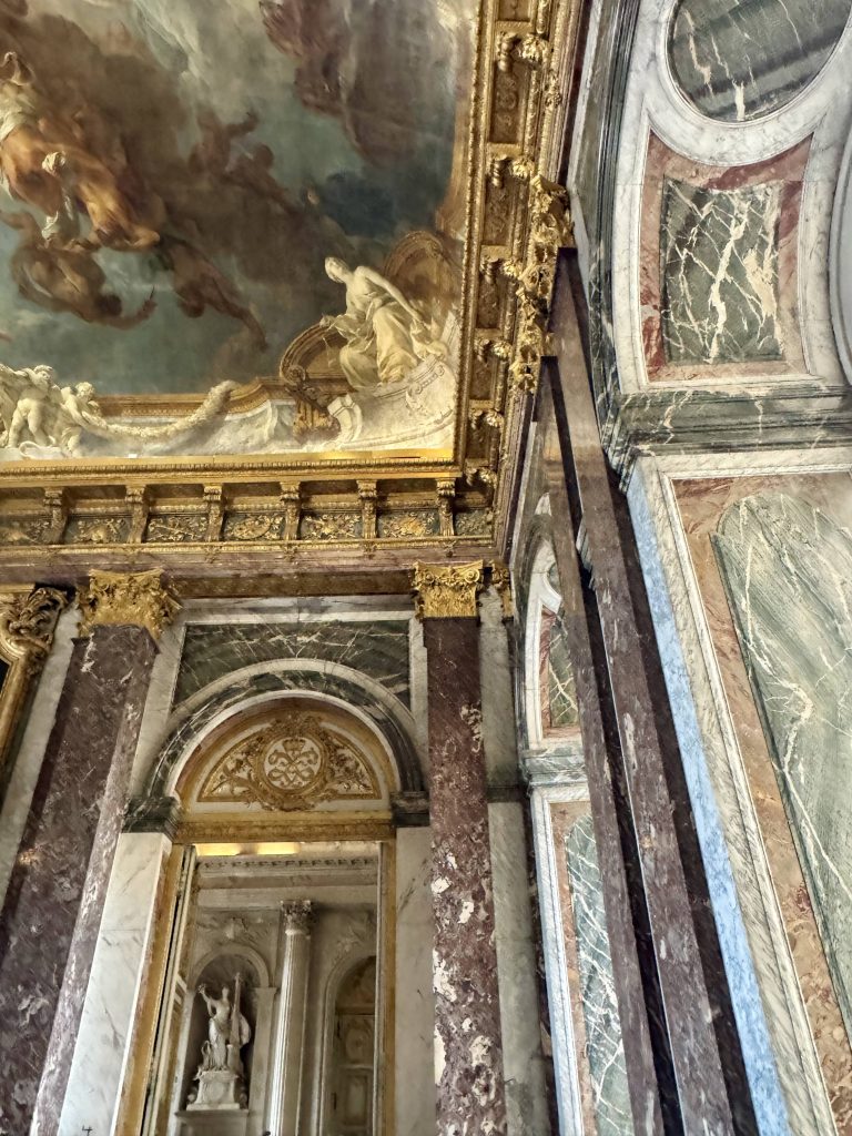Corner of a Versailles interior with marble panels and painted ceiling