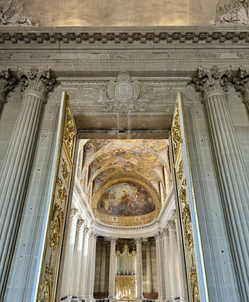 Classical stone columns surrounding an ornate palace interior