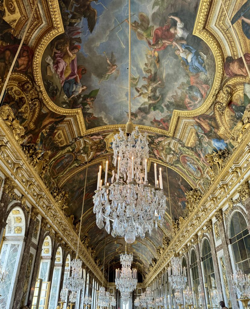 Chandeliers beneath the gilded and painted ceiling of the Hall of Mirrors