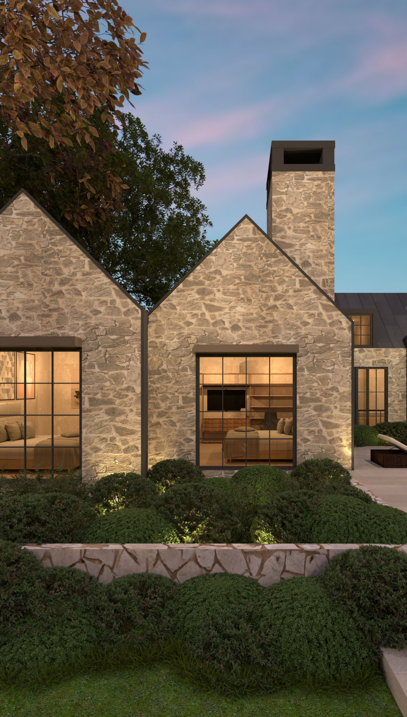 Stone gables and tall chimney beside garden planting