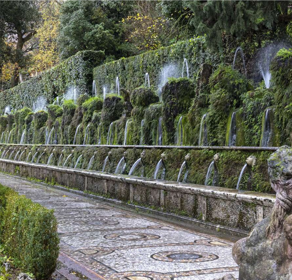 Tree-lined stone garden path beside a balustrade