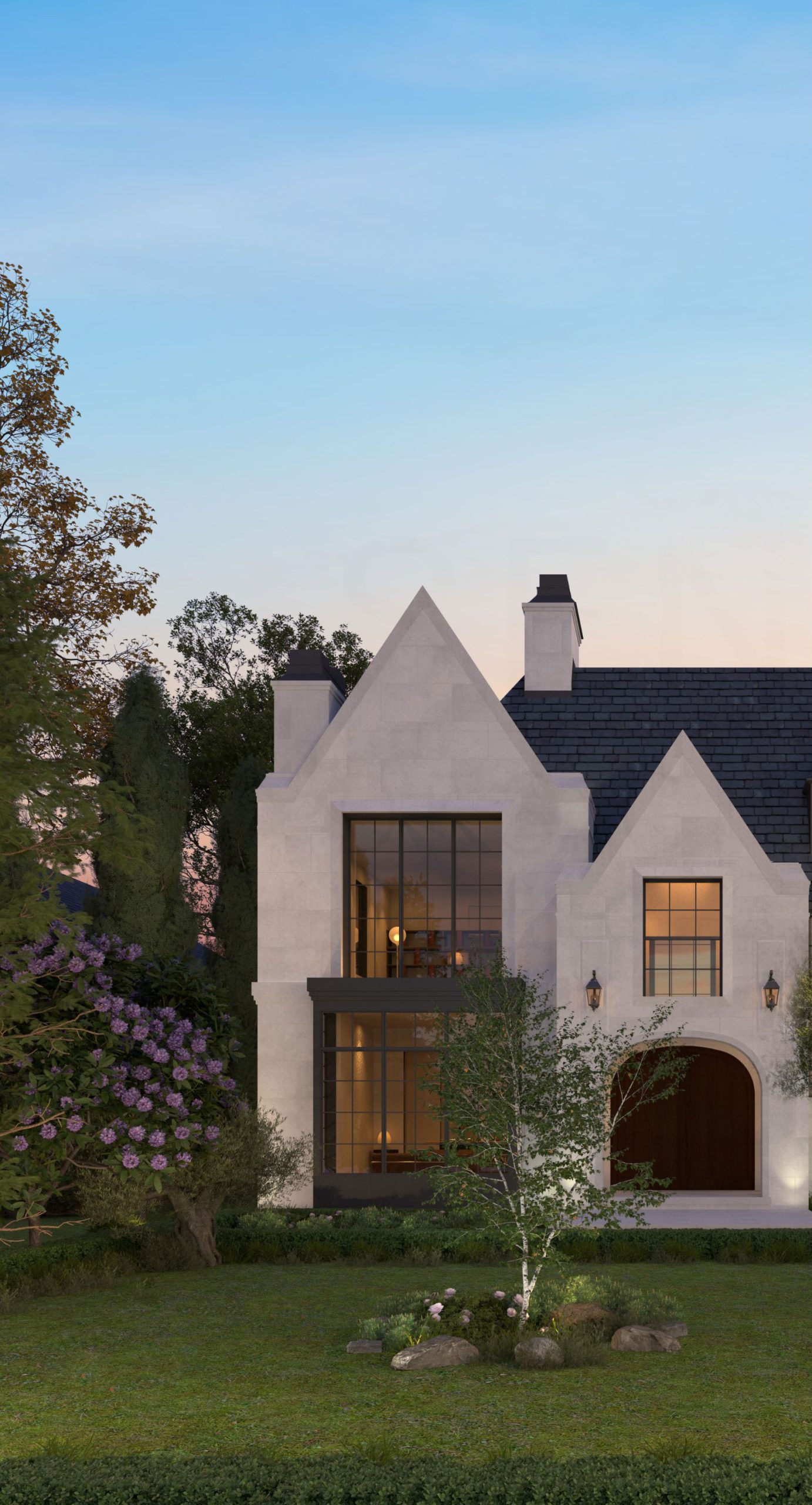 Stone gabled home beside a landscaped lawn