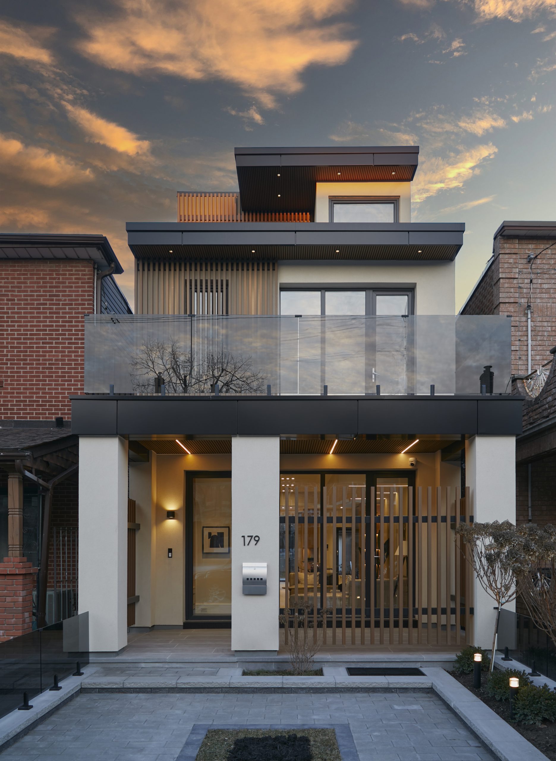 Covered rear entrance and wood-clad laneway suite