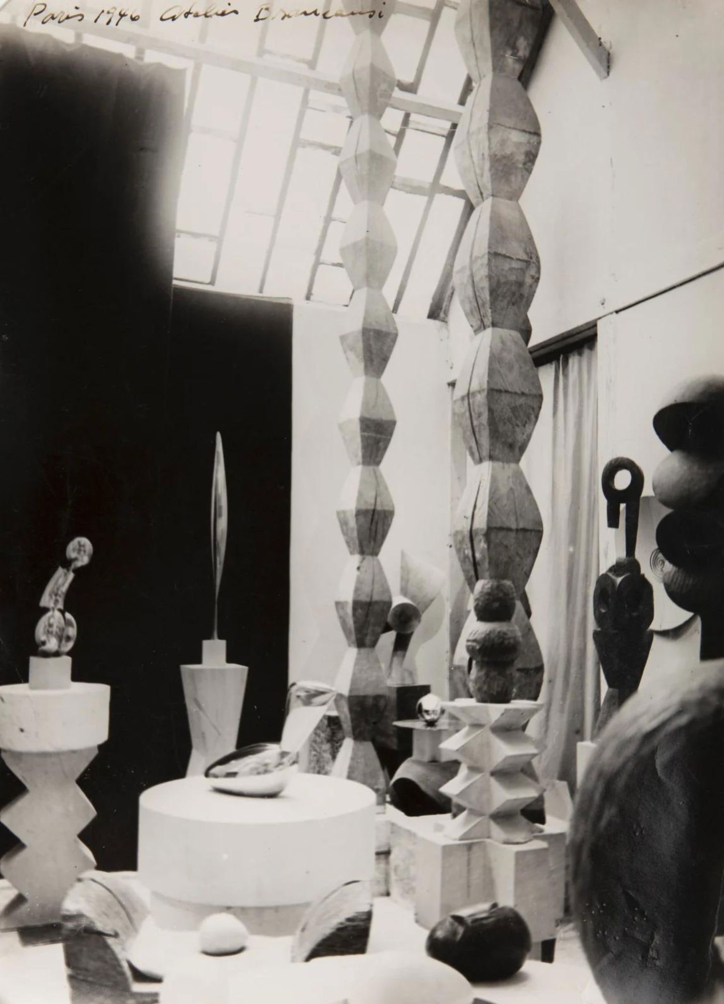 Daylight illuminating sculptures and stacked forms in a studio