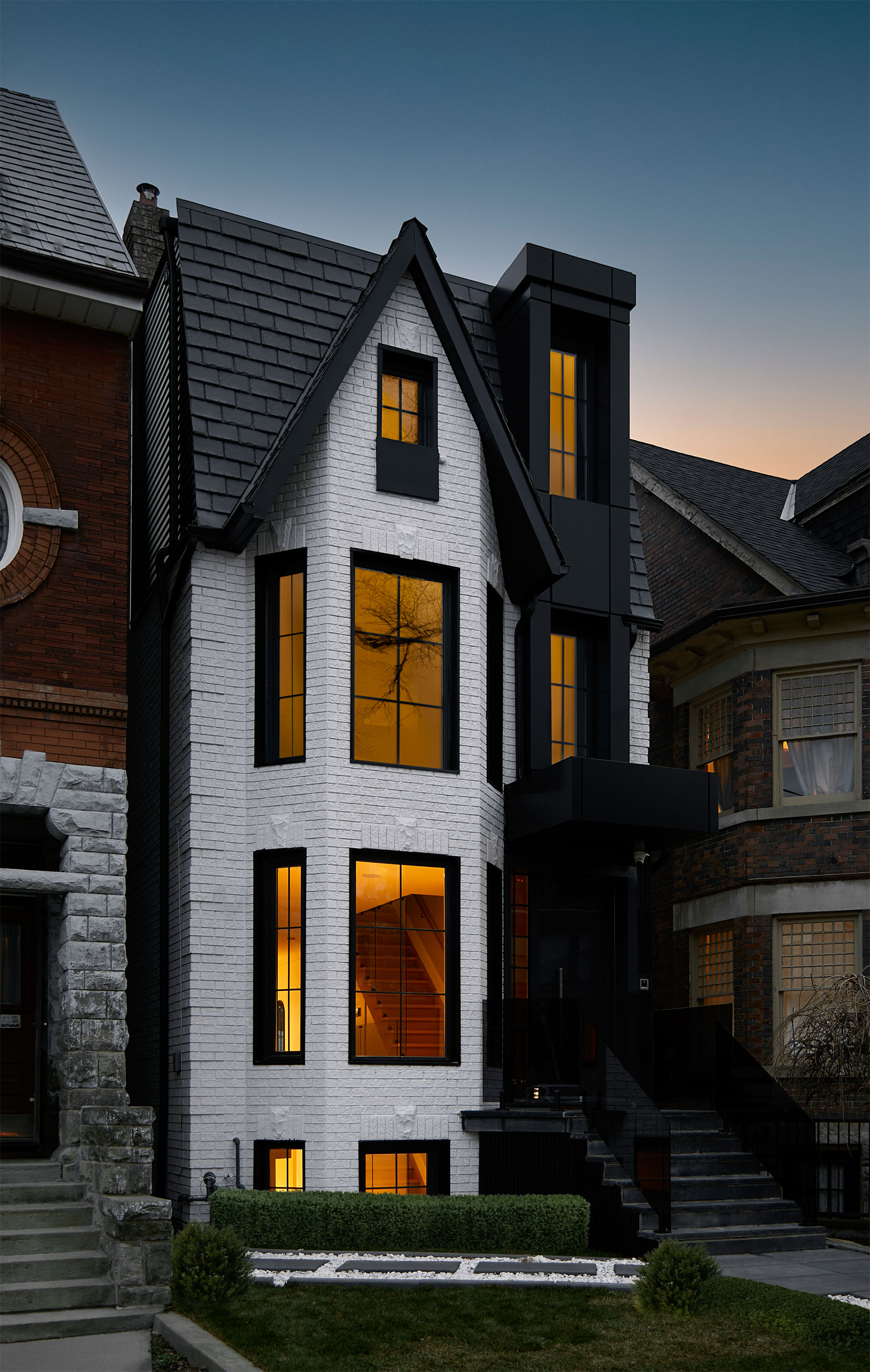 Angled twilight view of the renovated Victorian facade