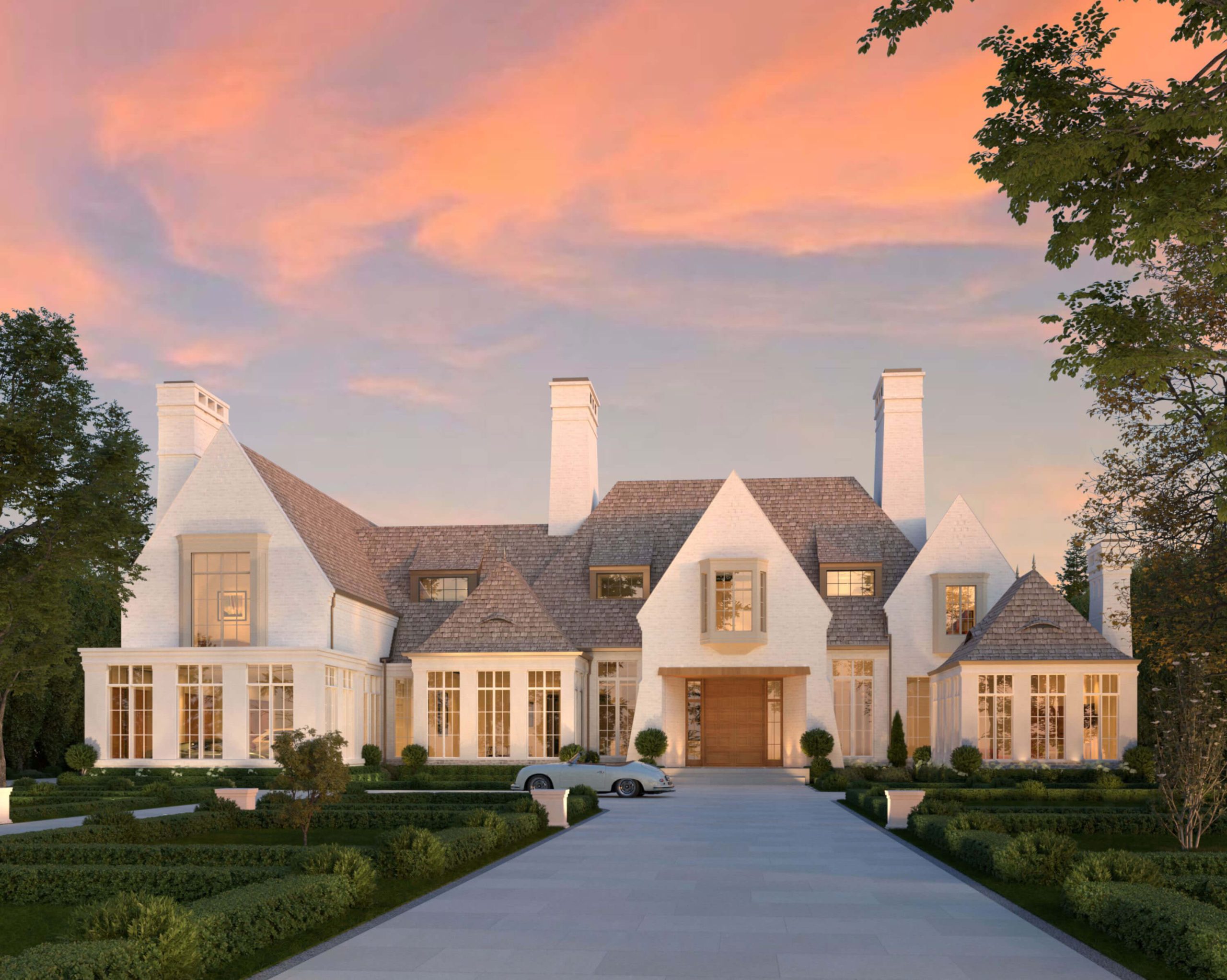 Traditional English Manor with white brick and cedar roof at sunset