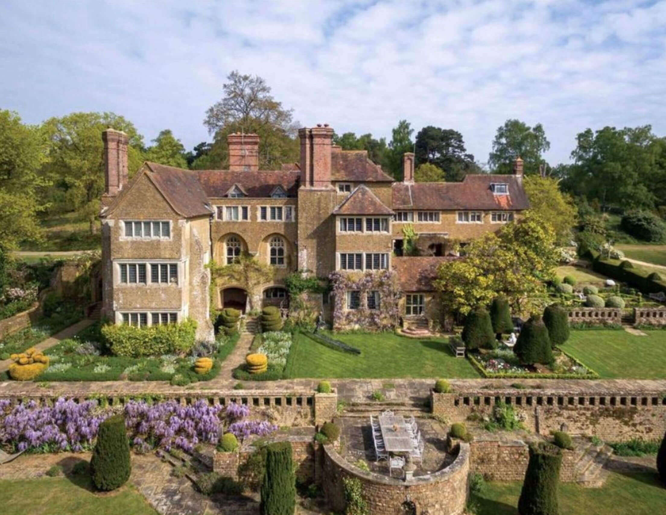 Stone manor and terraces surrounded by gardens