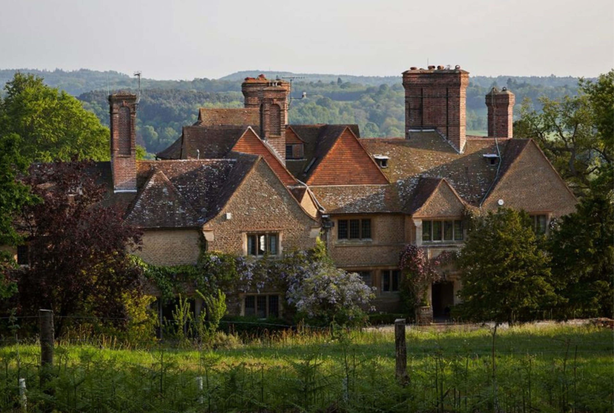 Tiled roofs and tall chimneys of a country house
