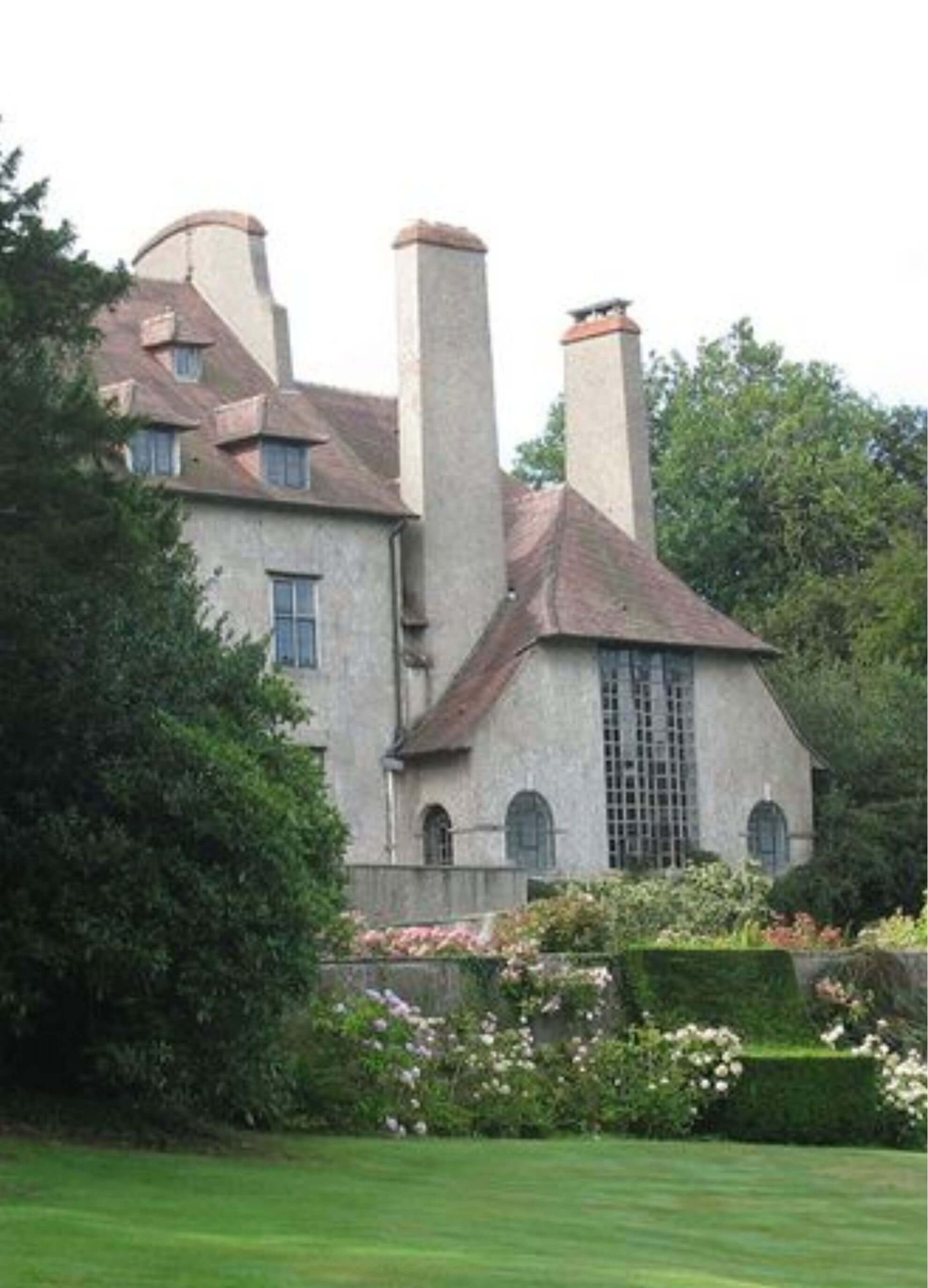 Pale house and garden framed by trees