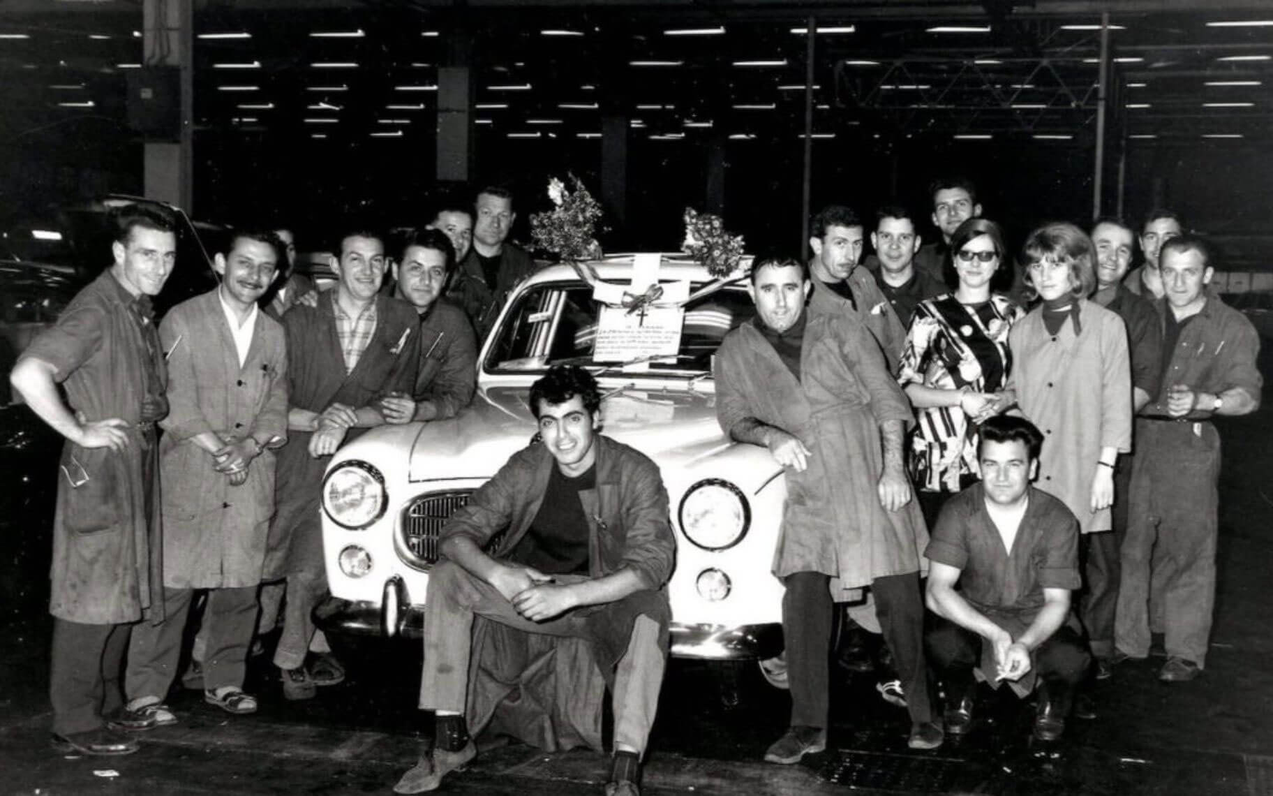 Workshop team gathered around a car