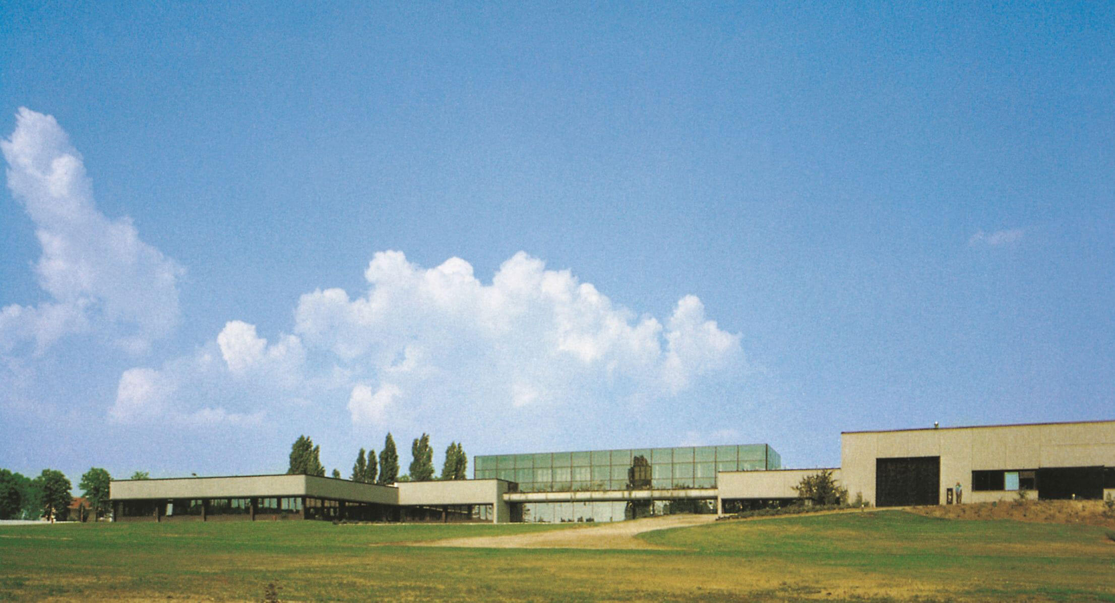 Low modern industrial building beneath a blue sky