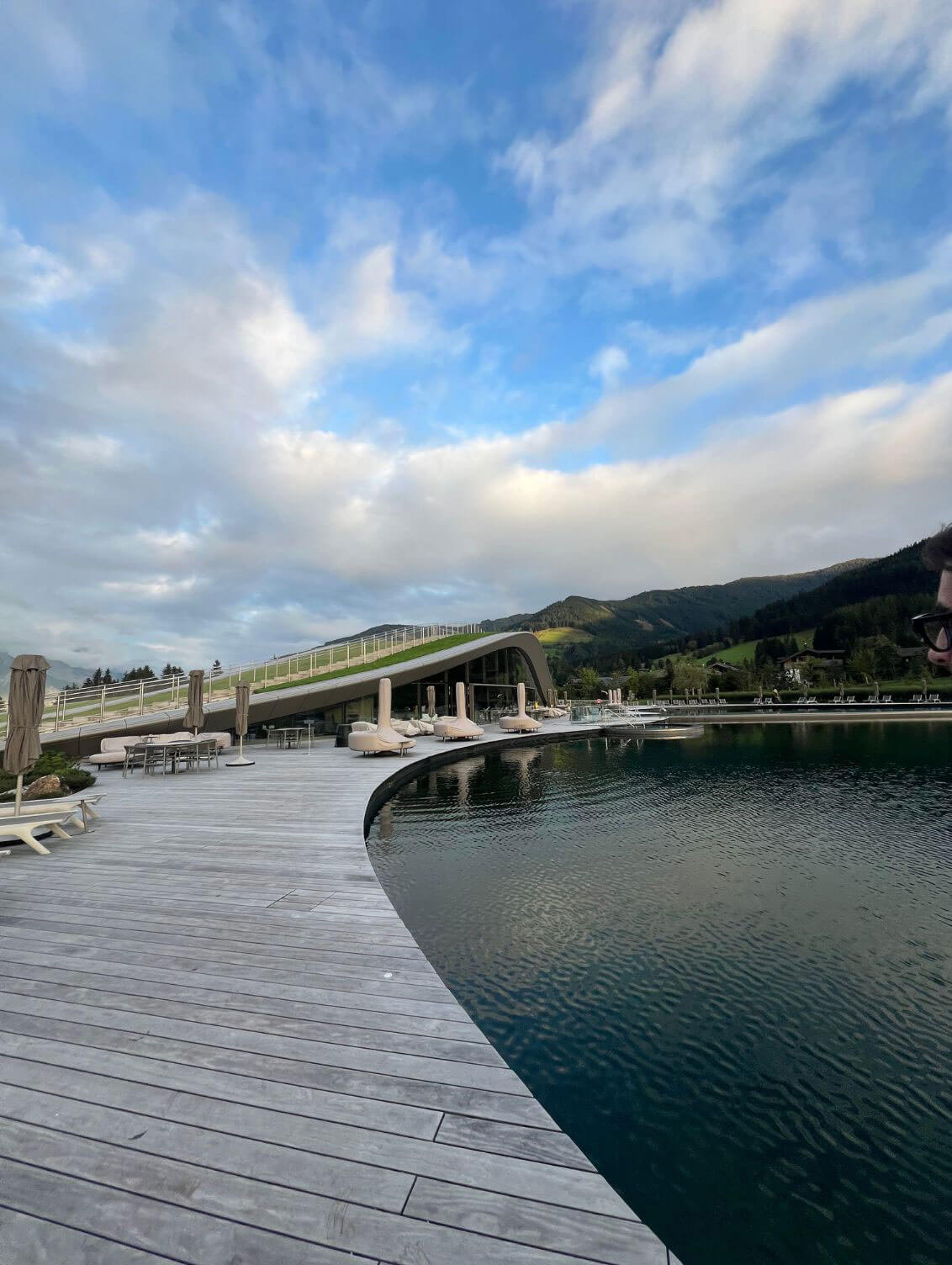 Riverfront walkway and bridge beneath a blue sky