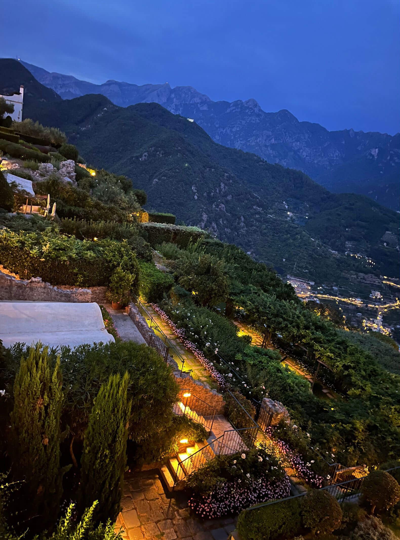 Terraced gardens and coastal mountains at dusk