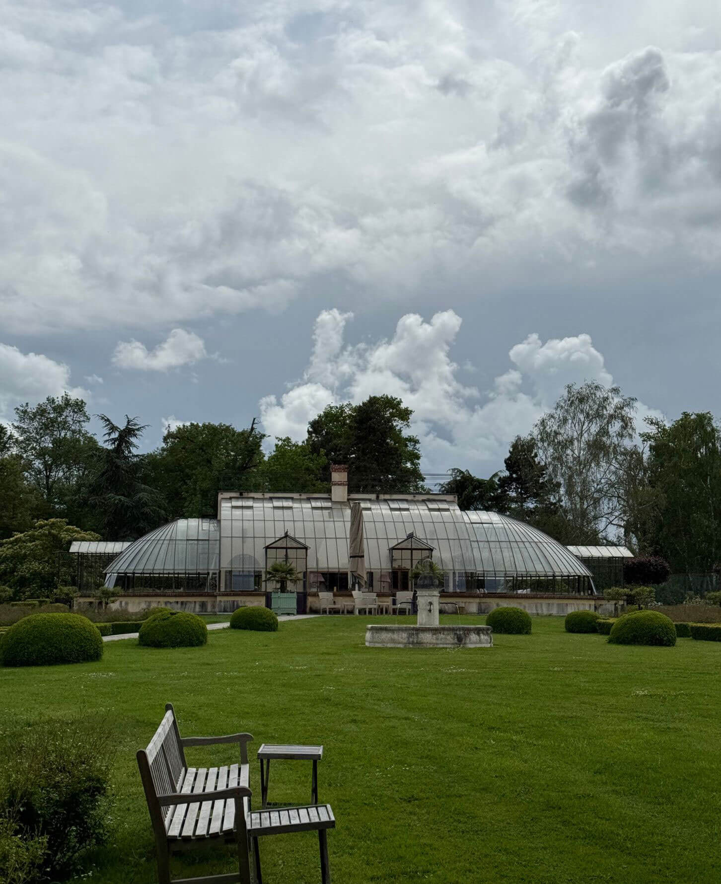 Glazed orangery beyond a broad garden lawn