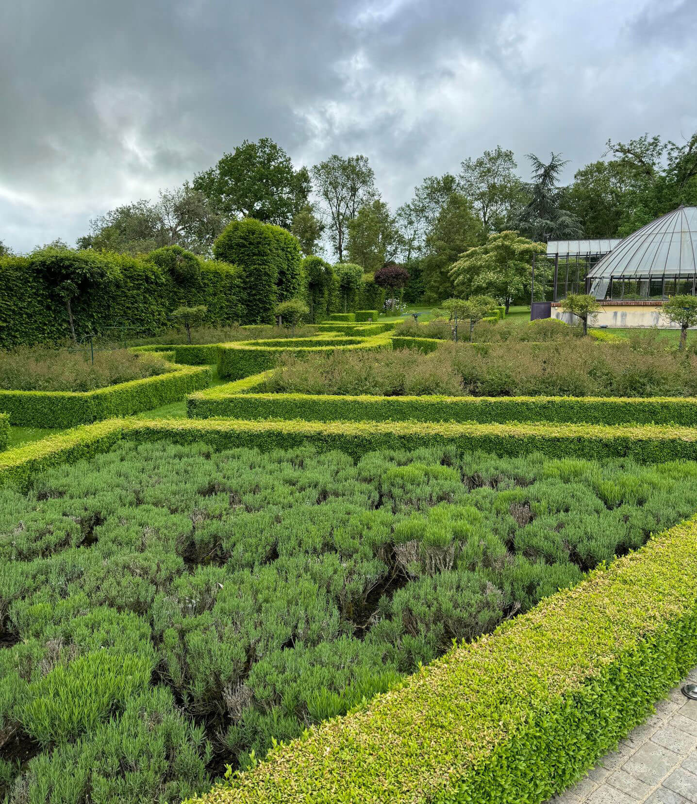 Geometric hedges surrounding planted garden beds