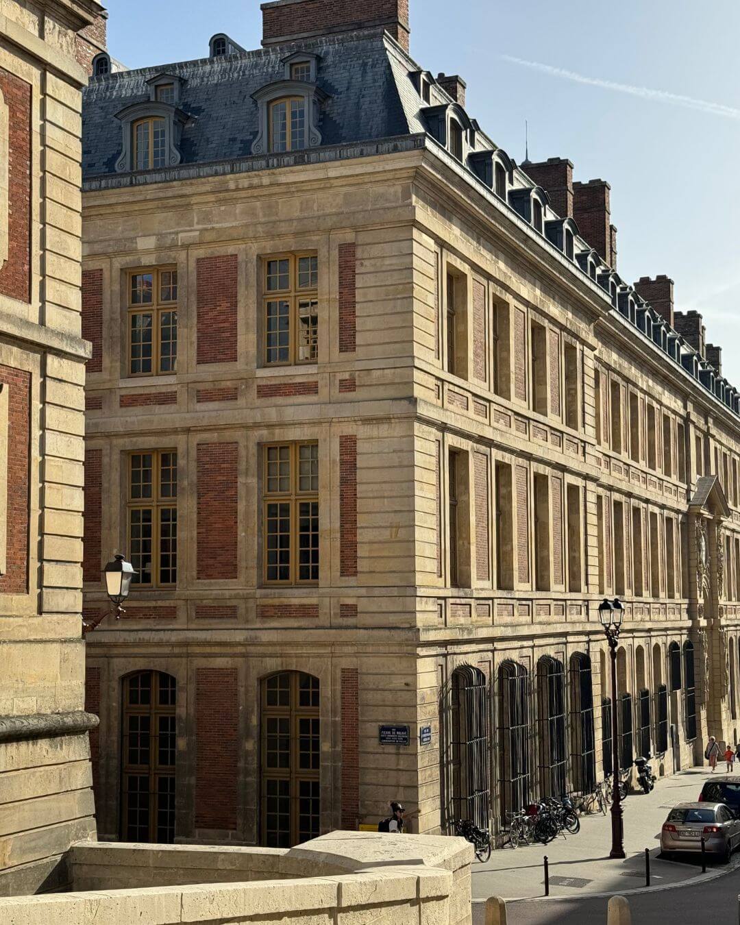 Historic stone city buildings with tall windows and slate roofs