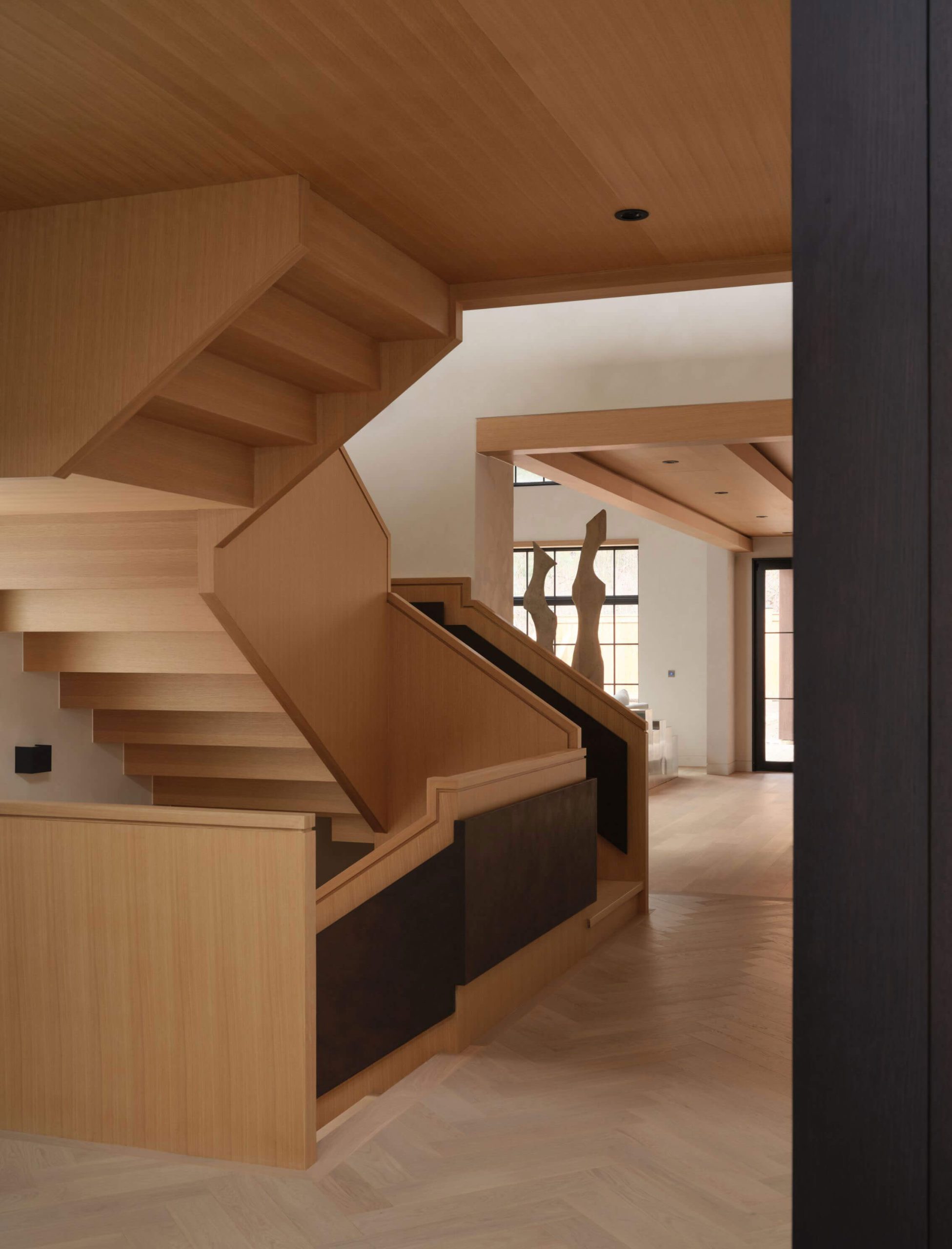 Sculptural white oak staircase and mezzanine