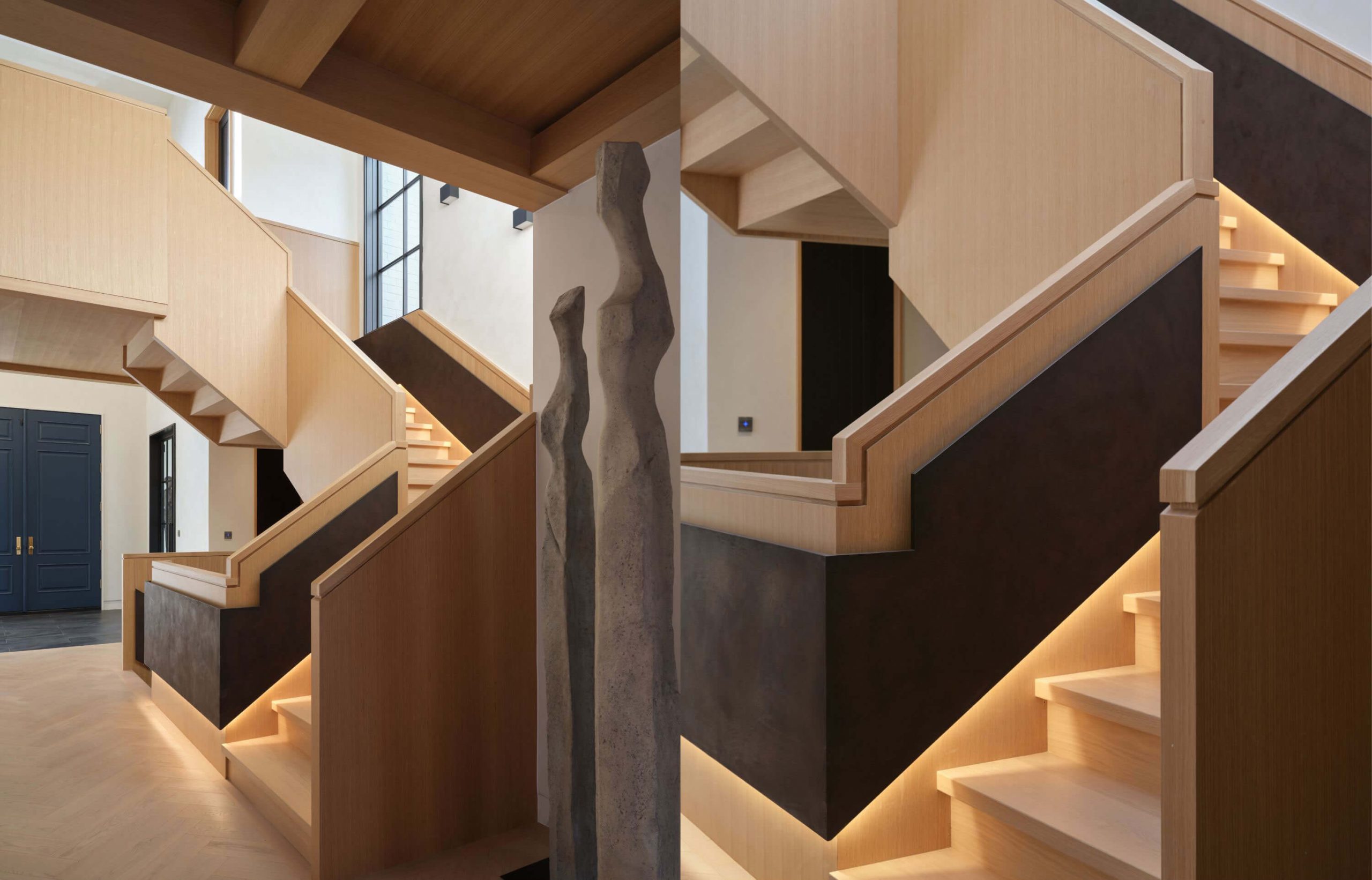 White oak staircase rising through the double-height interior