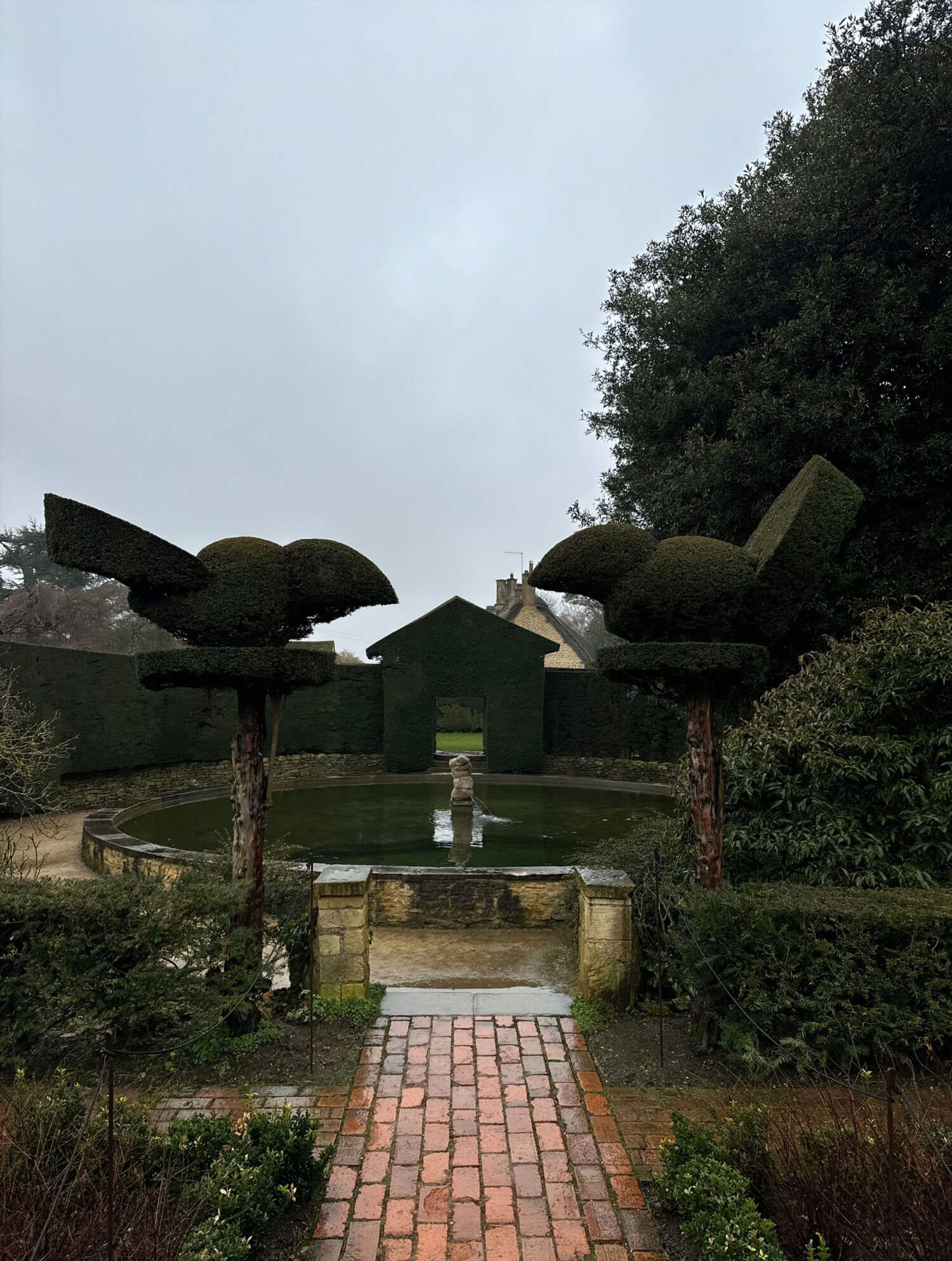 Tiered topiary beside brick steps