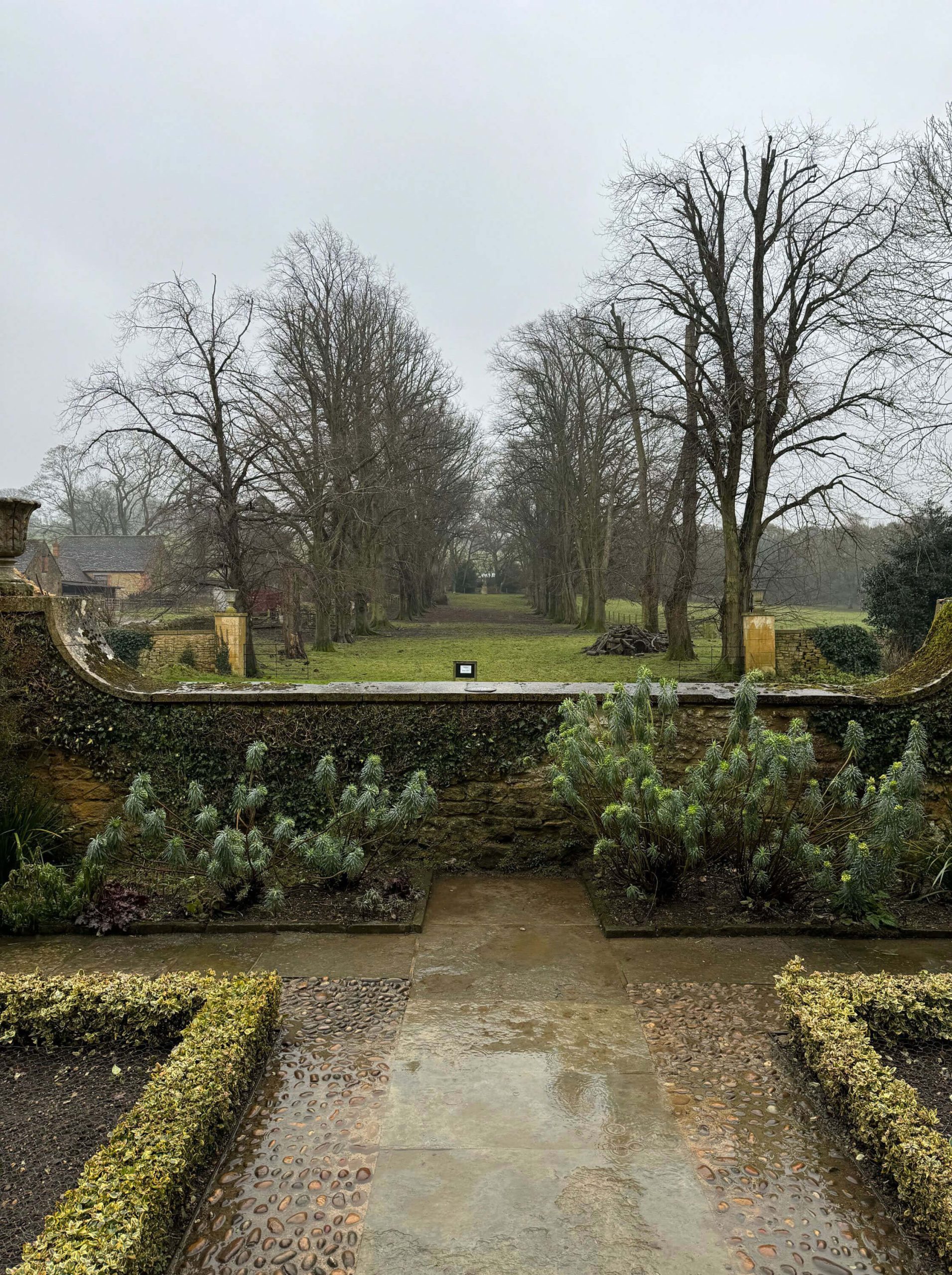 Stone balustrade overlooking lawns and mature trees