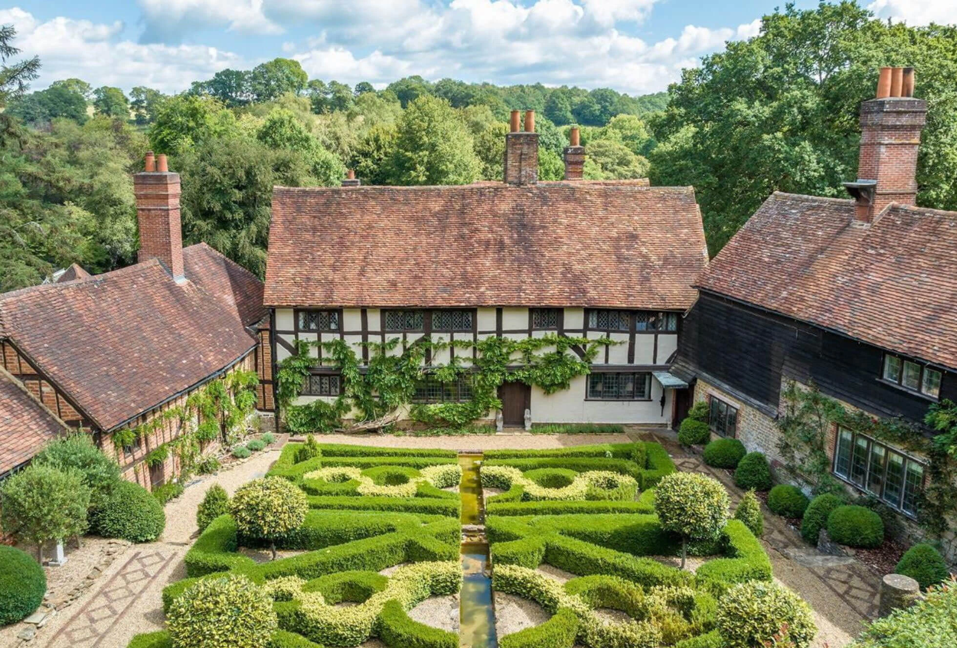 Country house surrounded by a patterned formal garden
