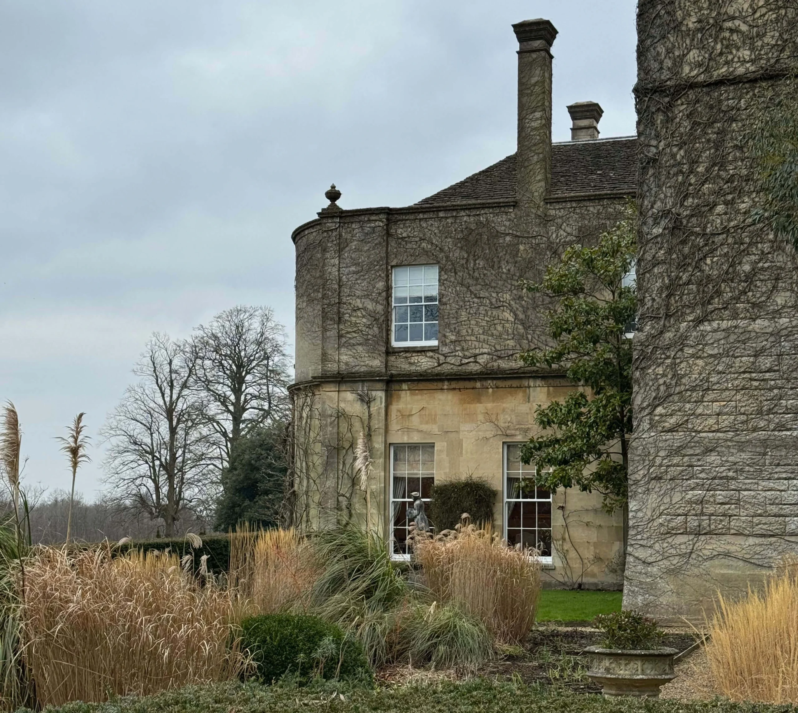 Stone manor wing with a tall chimney