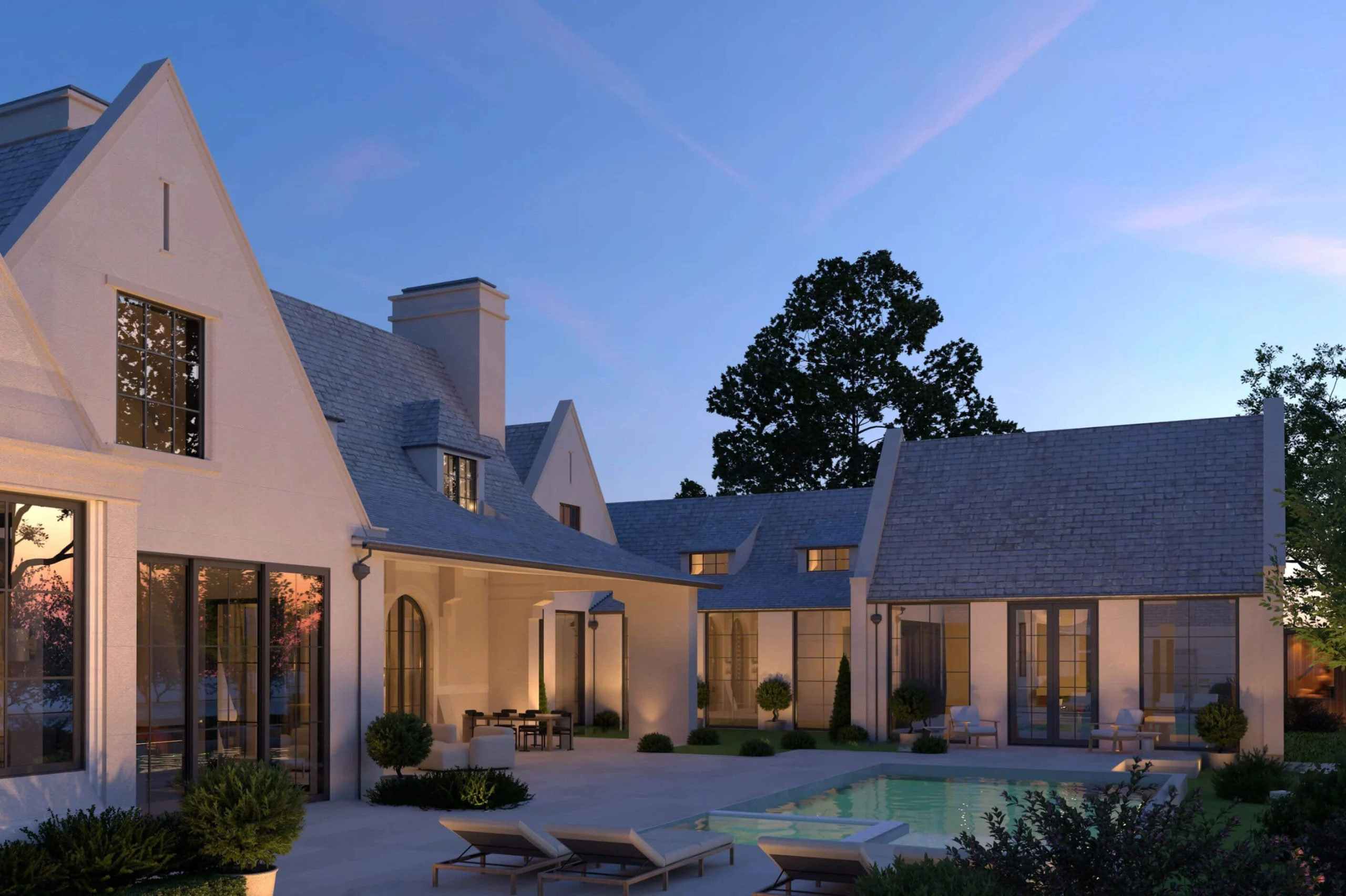 Rear courtyard, pool deck and pool house of the Tudor Country Home