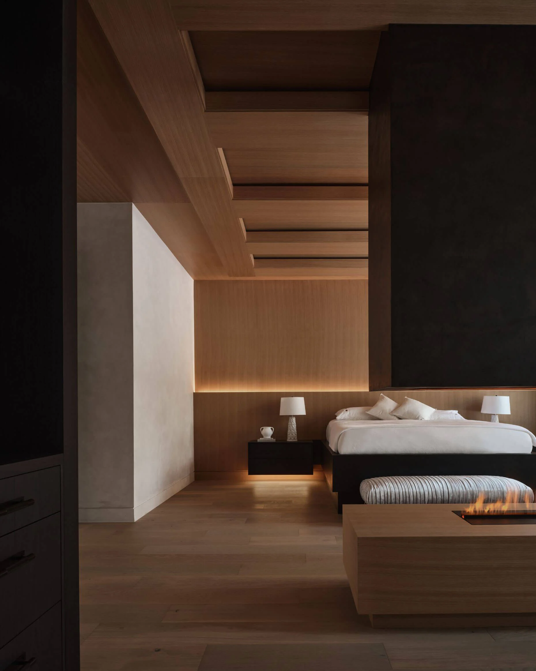 White oak bedroom with a patinated bronze fireplace