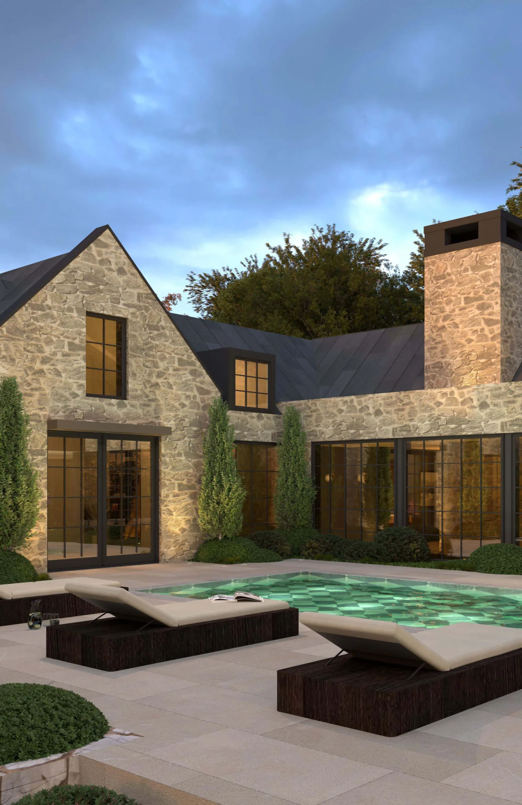 Garden terrace and pool beside a stone residence