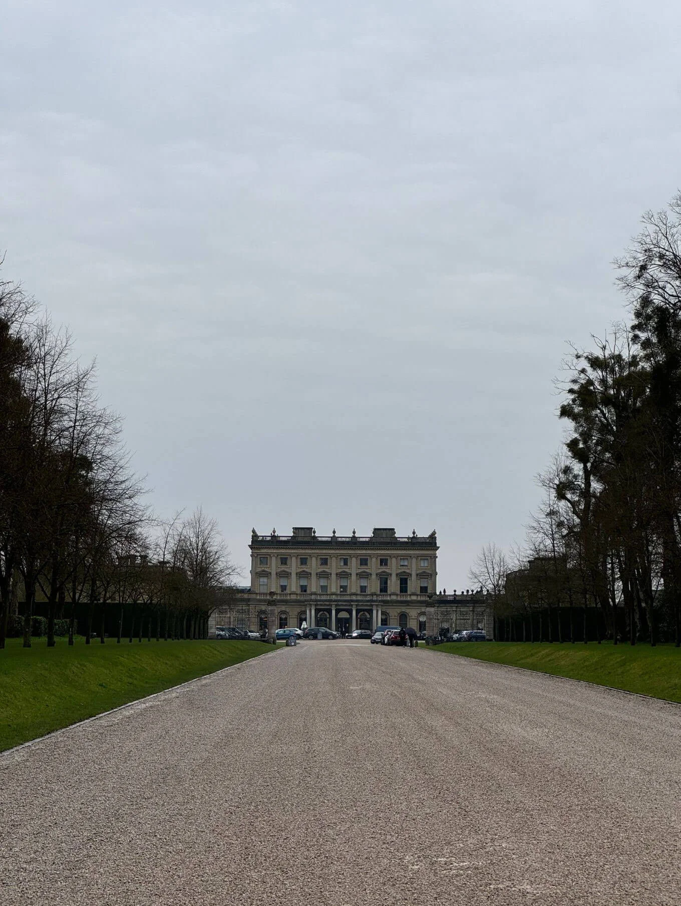 Long gravel drive approaching the symmetrical mansion