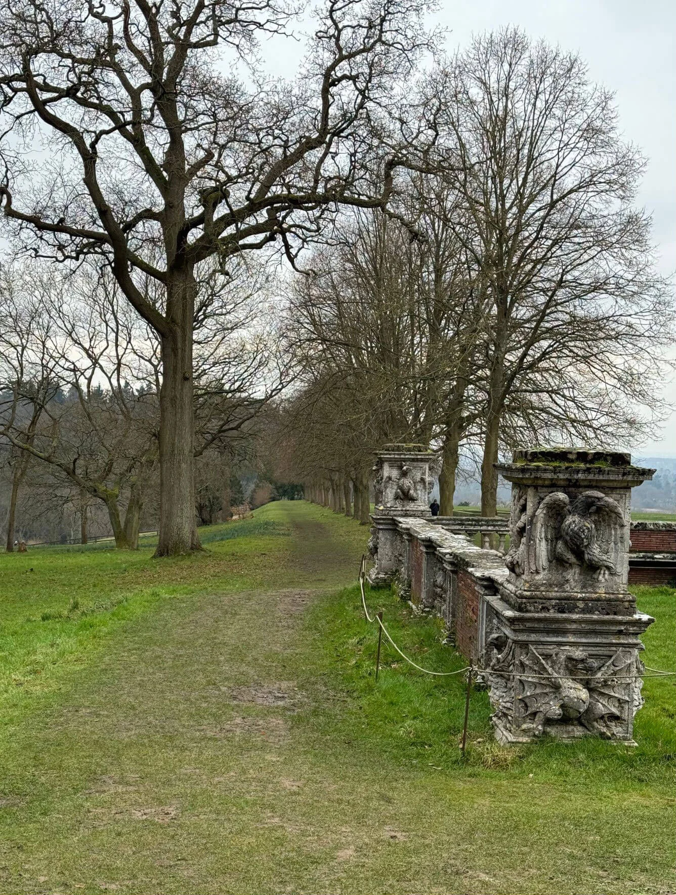 Woodland path beside a carved stone balustrade