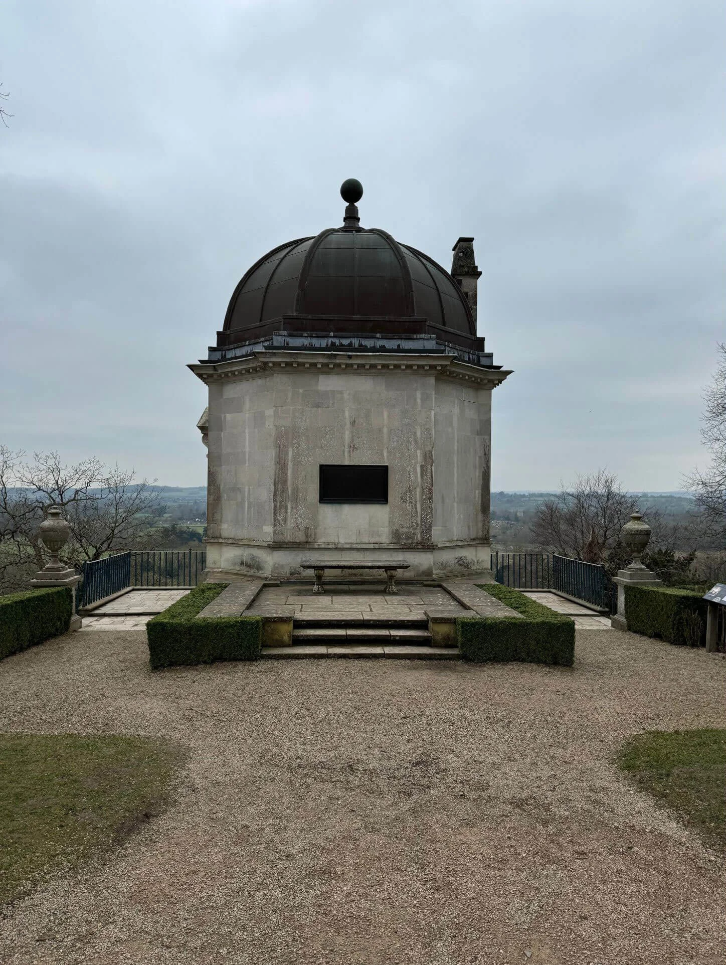 Domed stone garden pavilion above a gravel terrace