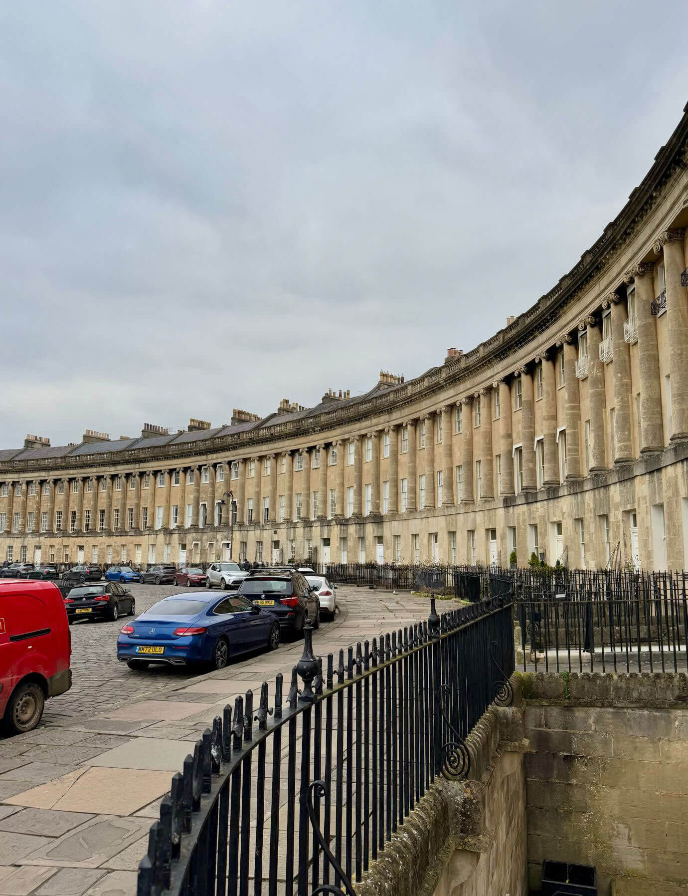 Curved classical stone terrace beside a street